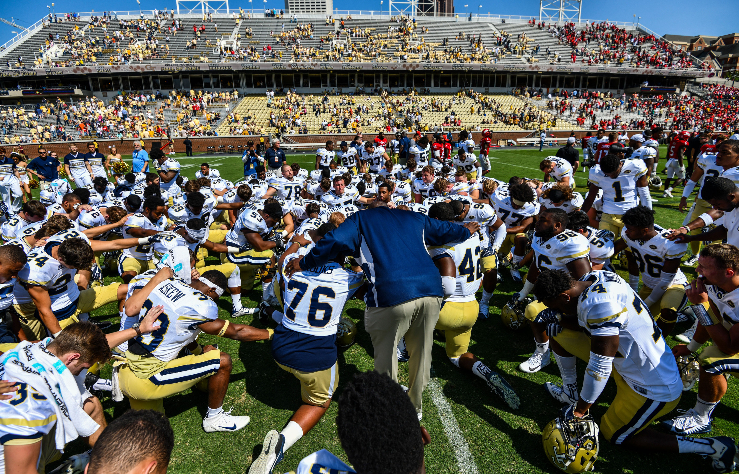 Team Chaplain Derrick Moore prays with the team after the win
