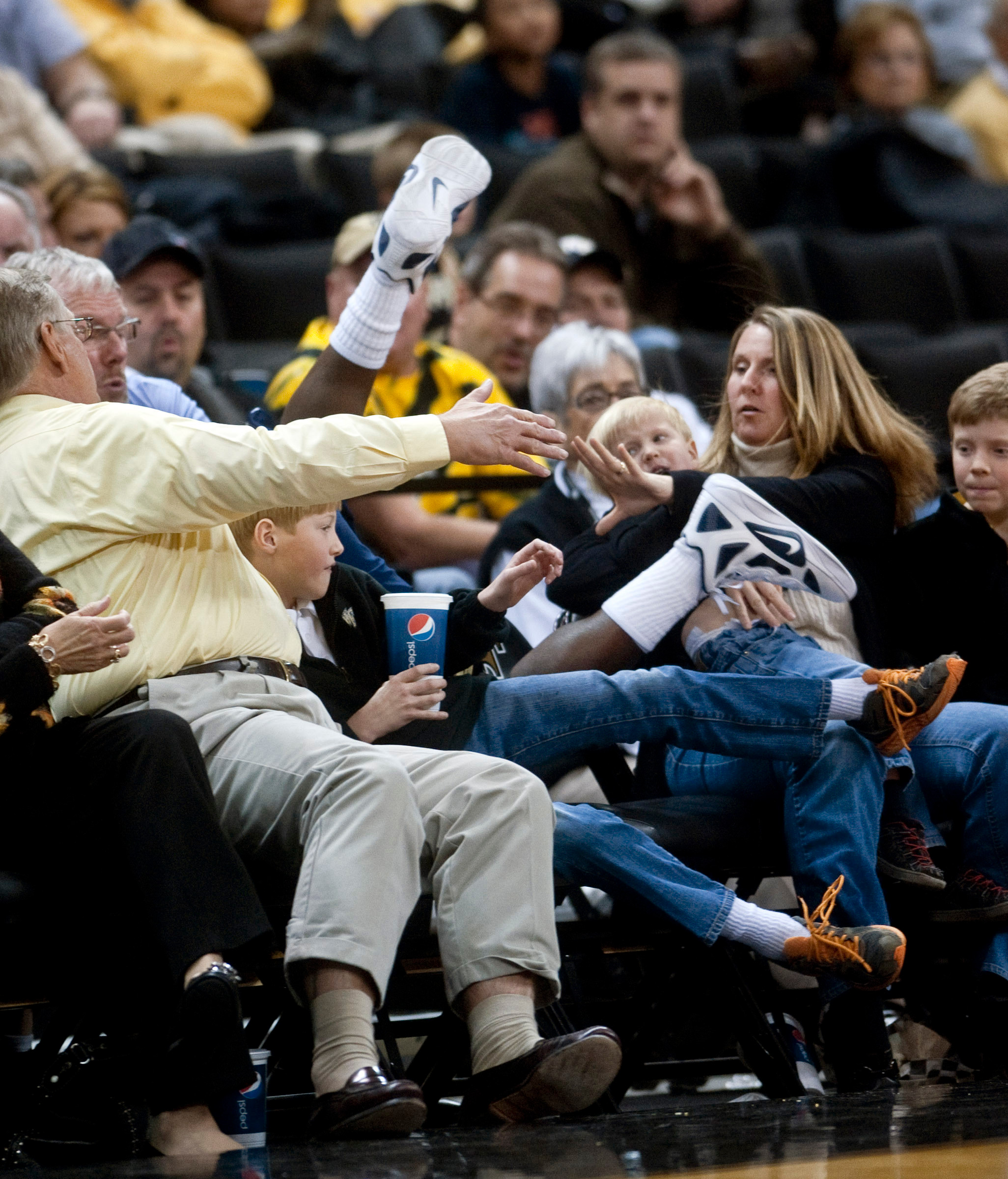 Georgia Tech's Mfon Udofia falls into a row of floor seats while attempting to keep the ball in play during the second half. (AP Photo/Winston-Salem Journal, Lauren Carroll)