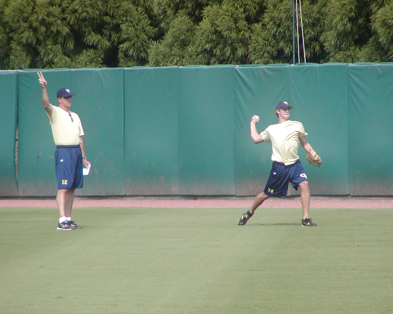 Tom Kinkelaar works with freshman Luke Bard.