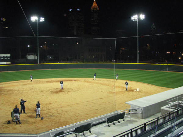 Softball team practices at night for the first time in its new stadium.