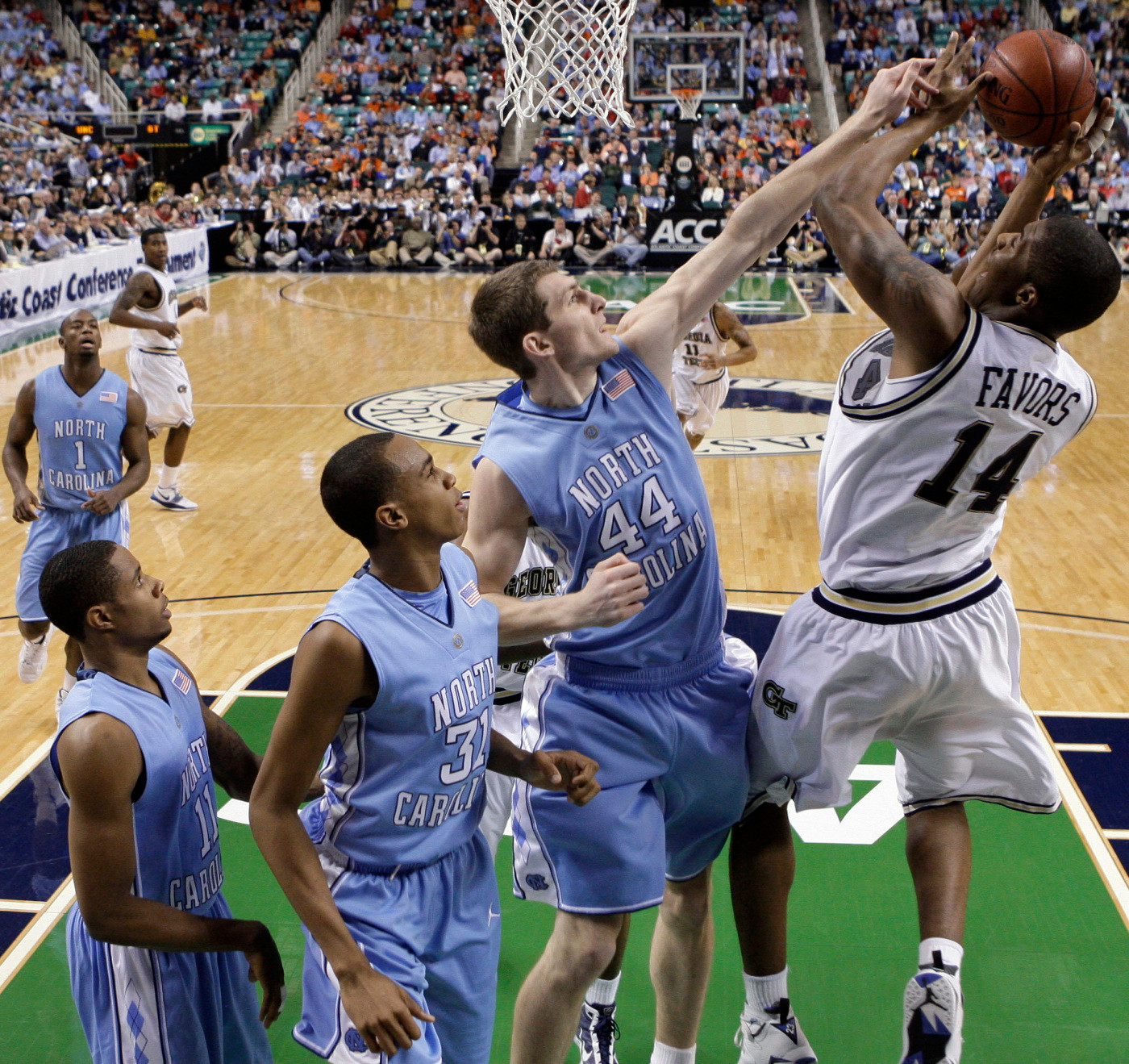 Georgia Tech's Derrick Favors (14) takes a shot as North Carolina's Tyler Zeller (44), John Henson (31) and Larry Drew II, left, defend during the first half of an NCAA college basketball game in the Atlantic Coast Conference tournament in Greensboro, N.C., Thursday, March 11, 2010. (AP Photo/Chuck Burton)