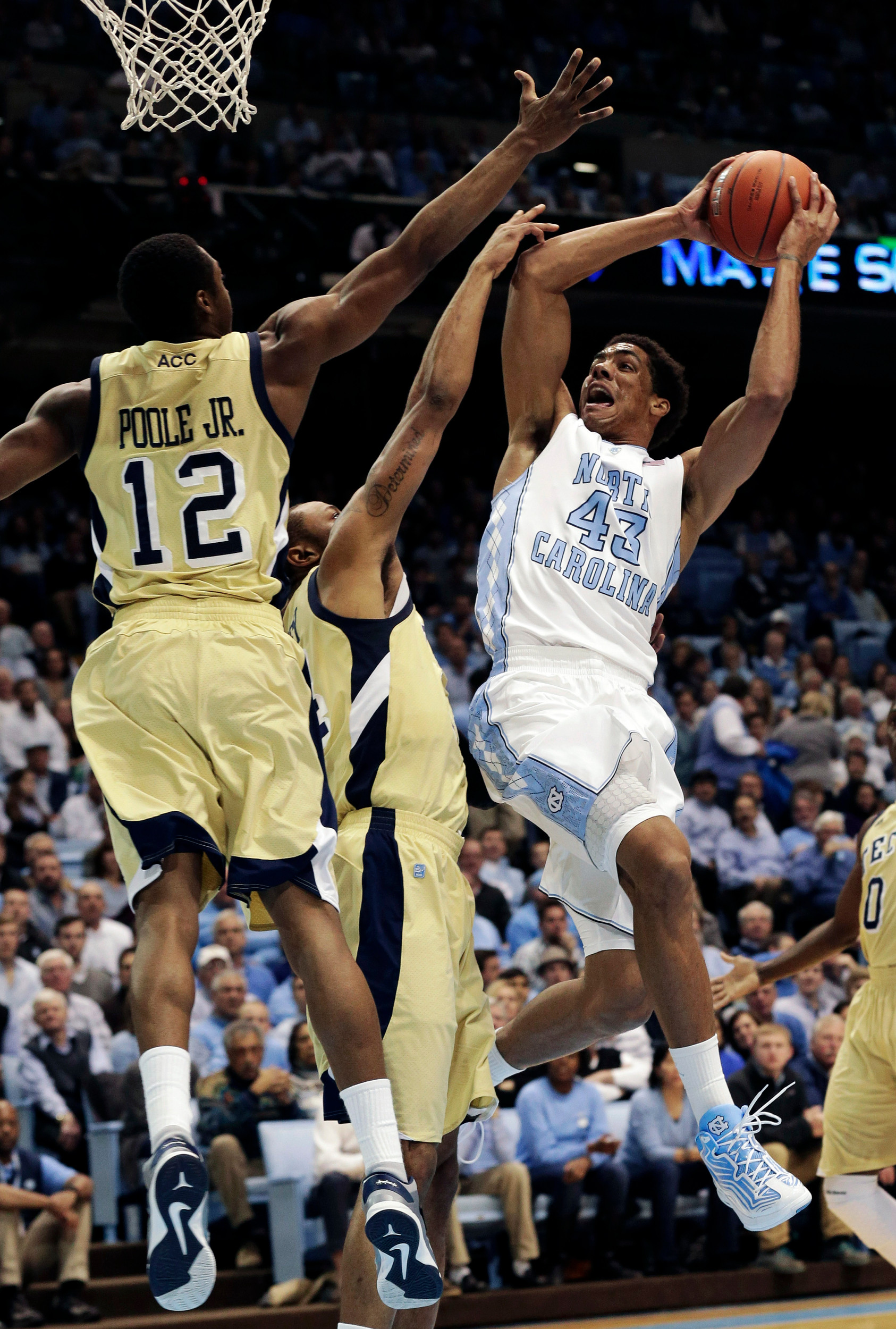 North Carolina's James Michael McAdoo (43) shoots as Georgia Tech's Stacey Poole Jr. (12) and Kammeon Holsey defend during the first half. (AP Photo/Gerry Broome)