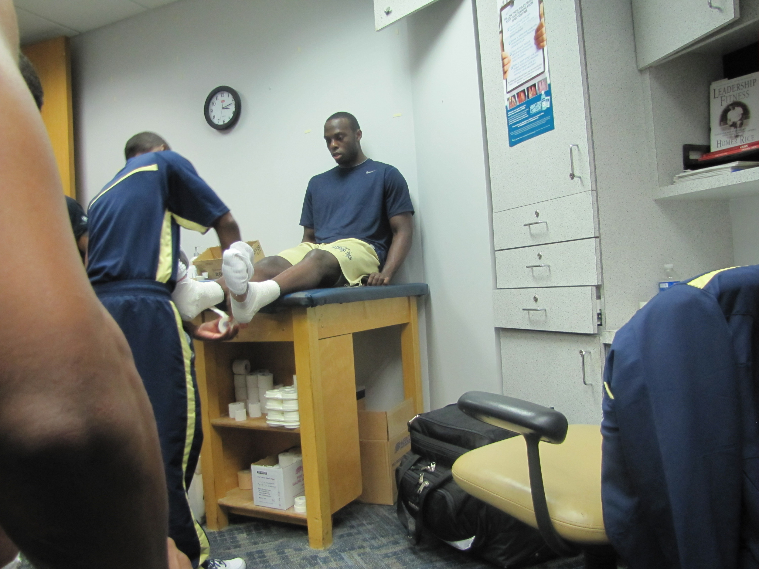 Mfon Udofia gets hia ankles taped before practice Tuesday.