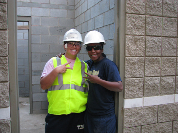 Caroline Hilton (left) and assistant coach Yolanda McRae check out the bathrooms.