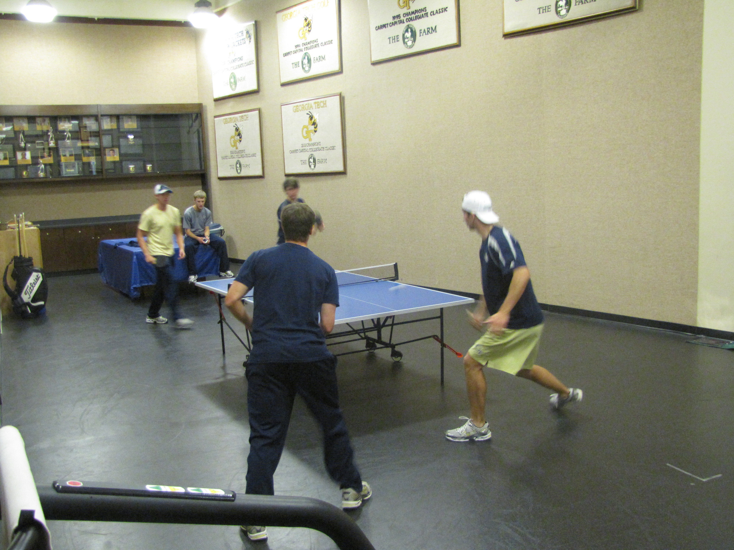 Tech golfers playing ping-pong in the team's workout room.