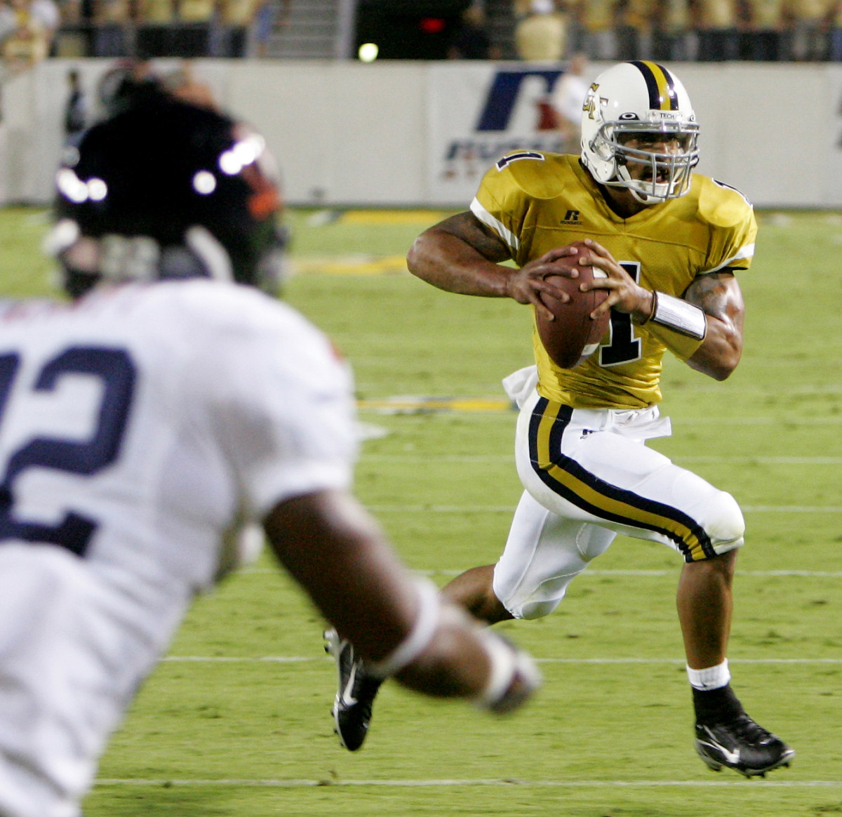 Georgia Tech quarterback Reggie Ball (1) breaks past Virginia safety Byron Glaspy (22) on his way to a first-half touchdown during a football game Thursday, Sept. 21, 2006, in Atlanta. (AP Photo/Ric Feld)