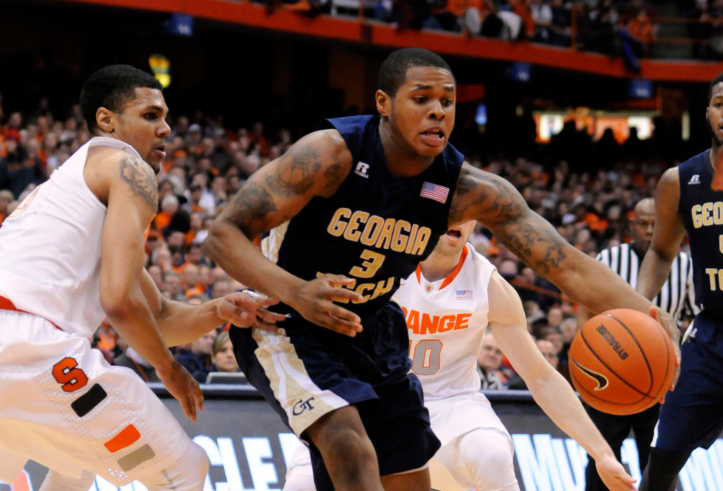 Mar 4, 2014; Syracuse, NY, USA; Georgia Tech Yellow Jackets forward Marcus Georges-Hunt (3) gets past Syracuse Orange guard Michael Gbinije (0) during the first half of a game at the Carrier Dome. Georgia Tech won the game 67-62. Mandatory Credit: Mark Konezny-USA TODAY Sports