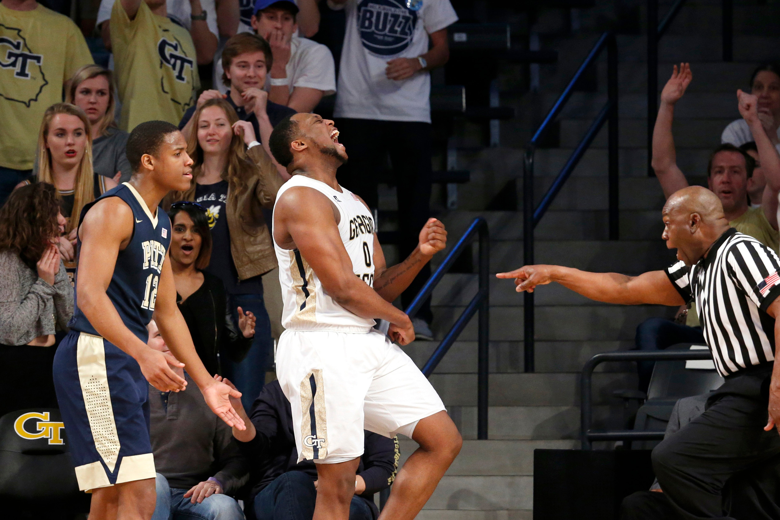 Mar 5, 2016; Atlanta, GA, USA; Georgia Tech Yellow Jackets forward Charles Mitchell (0) celebrates a play against Pittsburgh Panthers guard Chris Jones (12). Credit: Jason Getz-USA TODAY Sports