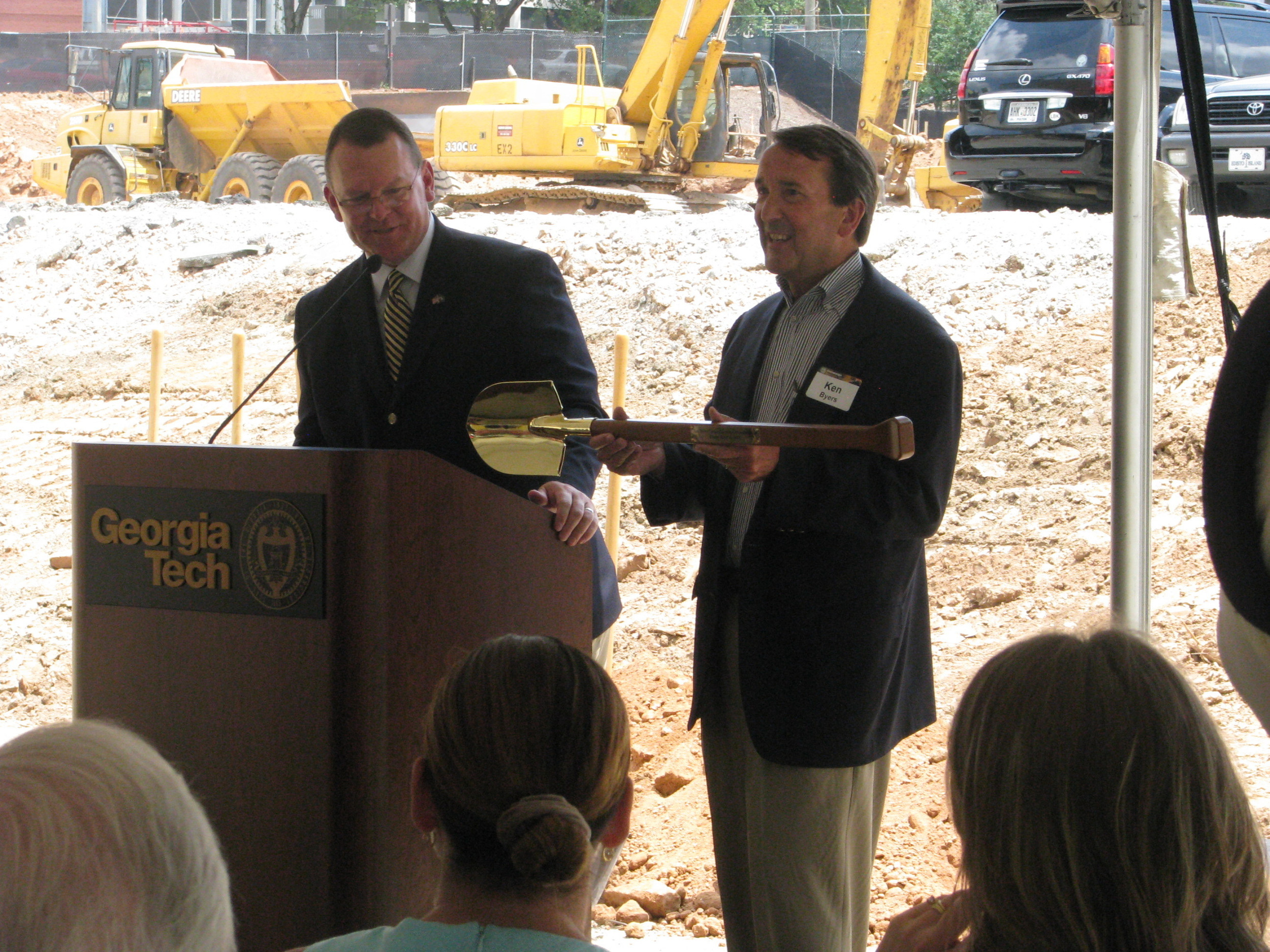 Wes Durham hands Ken Byers his souvenir shovel for the occasion at the Ken Byers Tennis Complex Groundbreaking Ceremony, June 15, 2012.