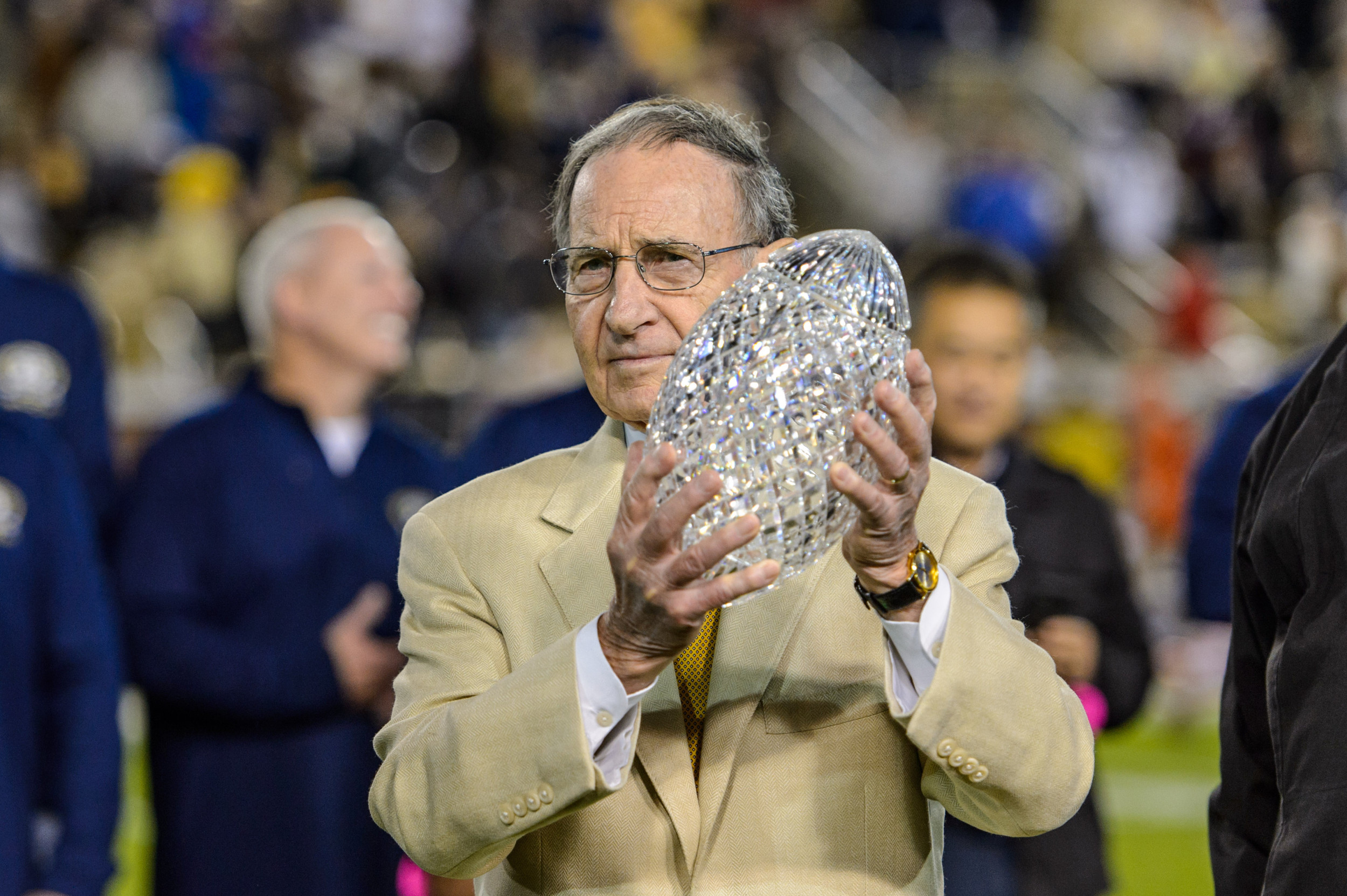 Former Athletic Director Homer Rice presents the 1990 National Championship trophy to Coach Bobby Ross