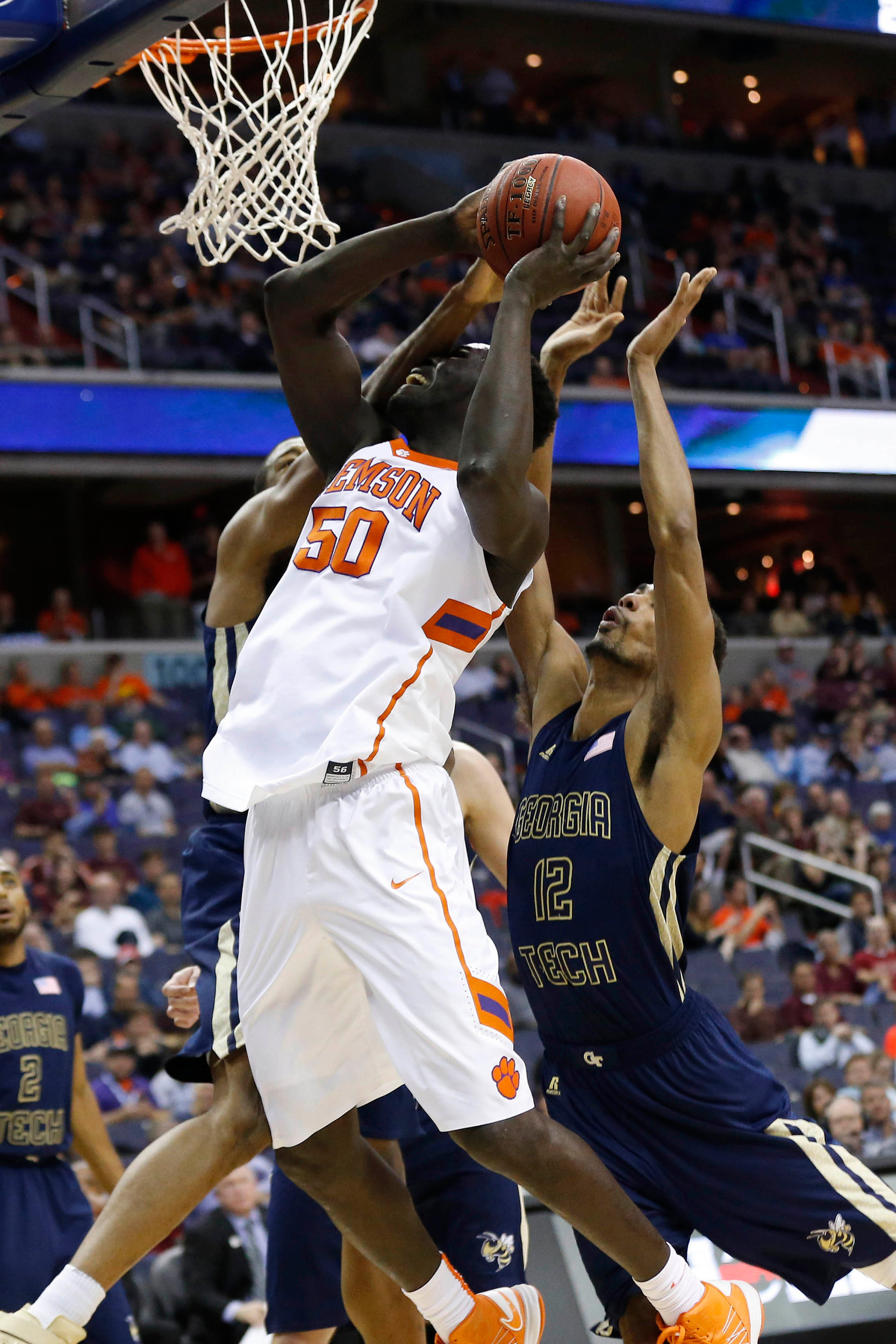 Mar 9, 2016; Washington, DC, USA; Clemson Tigers center Sidy Djitte (50) shoots the ball as Georgia Tech Yellow Jackets forward James White (33) and Yellow Jackets forward Quinton Stephens (12) defend in the first half during day two of the ACC conference tournament at Verizon Center. Mandatory Credit: Geoff Burke-USA TODAY Sports