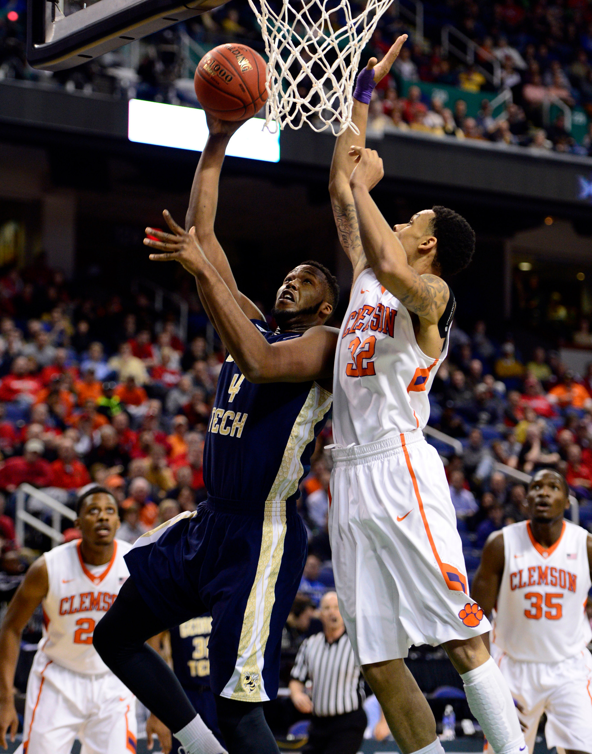 Mar 13, 2014; Greensboro, NC, USA; Georgia Tech Yellow Jackets forward Robert Carter, Jr. (4) drives to the basket against Clemson Tigers forward K.J. McDaniels (32) in the second round of the ACC college basketball tournament at Greensboro Coliseum. Mandatory Credit: John David Mercer-USA TODAY Sports