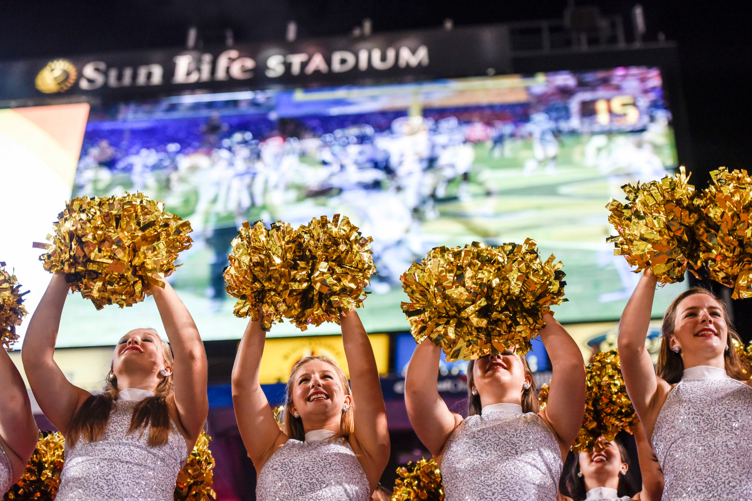 Dec 31, 2014; Miami Gardens, FL, USA; Georgia Tech Yellow Jackets cheerleaders react to a touchdown as the replay shows on the big screen in the second half of the Orange Bowl game at Sun Life Stadium. Georgia Tech defeated the Bulldogs 49-34. Mandatory Credit: Brad Barr-USA TODAY Sports