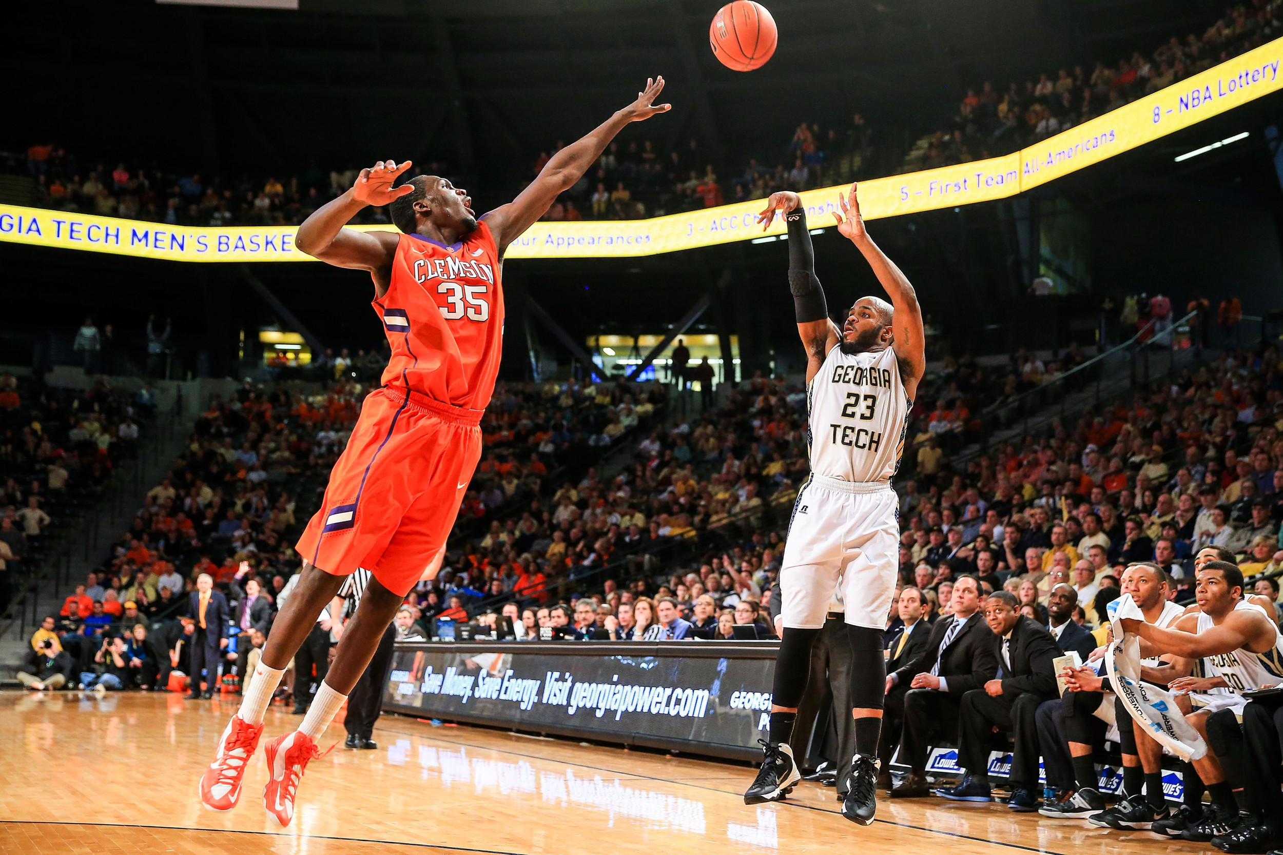 Feb 22, 2014; Atlanta, GA, USA; Yellow Jackets guard Trae Golden (23) shoots a three over Clemson Tigers center Landry Nnoko (35) in the second half. Daniel Shirey-USA TODAY Sports
