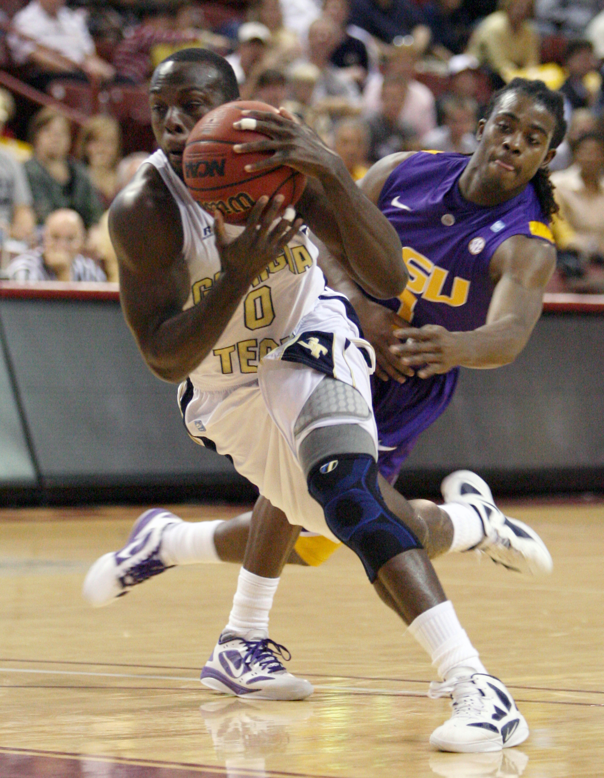 Georgia Tech's Mfon Udofia drives around the defense of LSU's Anthony Hickey during the first half. (AP Photo/Mic Smith)