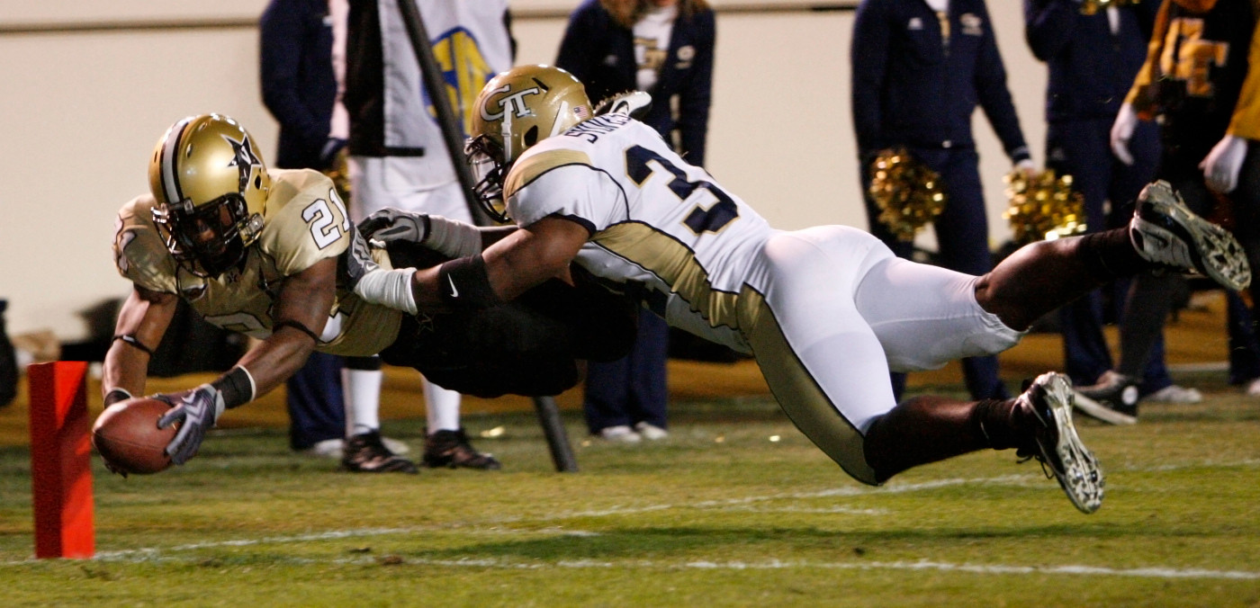 Vanderbilt running back Zac Stacy (21) dives and scores a touchdown as he is hit by Georgia Tech linebacker Steven Sylvester (34) in the first quarter. (AP Photo/Mark Humphrey)