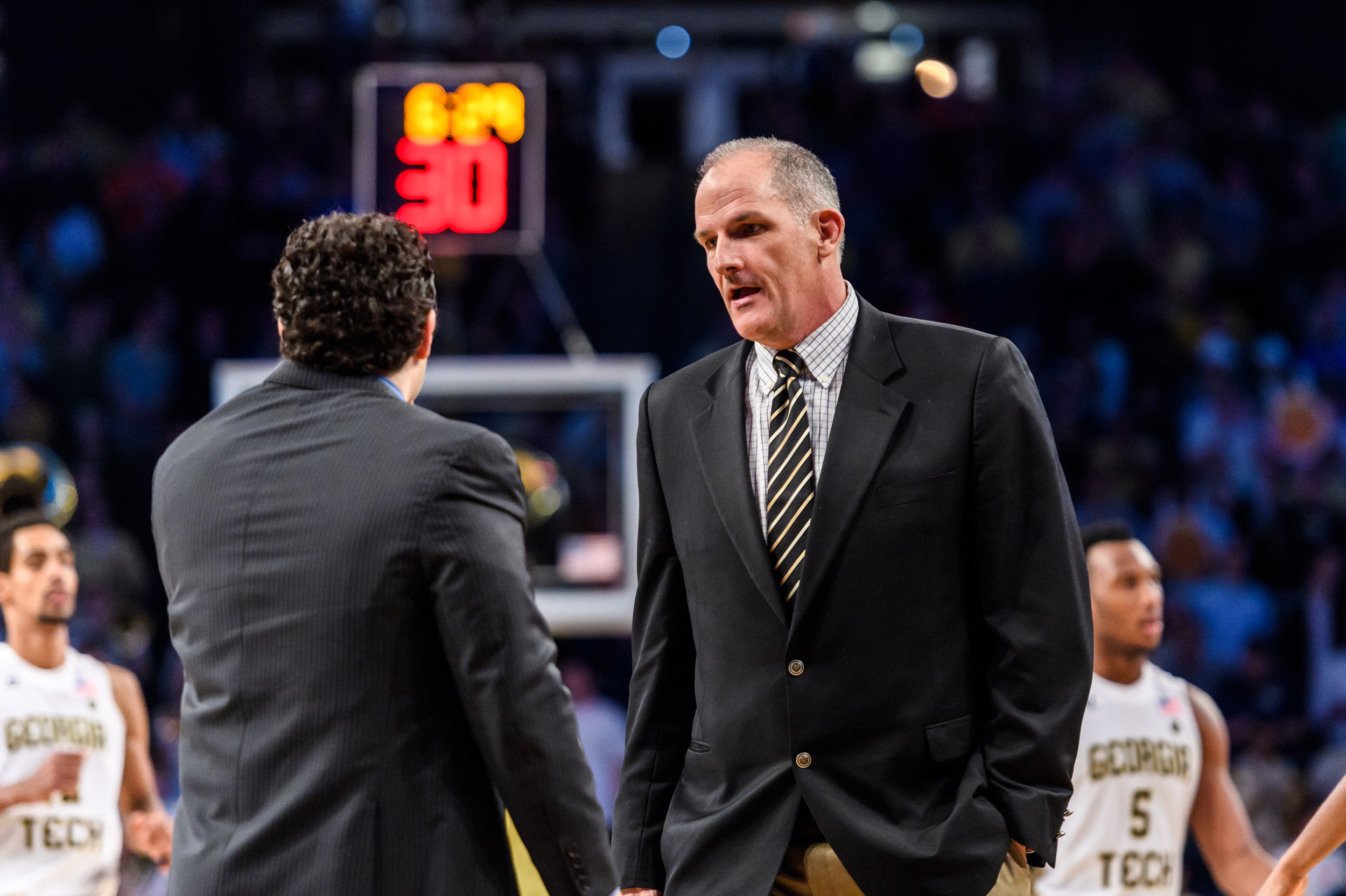 Assistant coach Eric Reveno chats with Coach Josh Pastner during Tech's victory over Florida State.