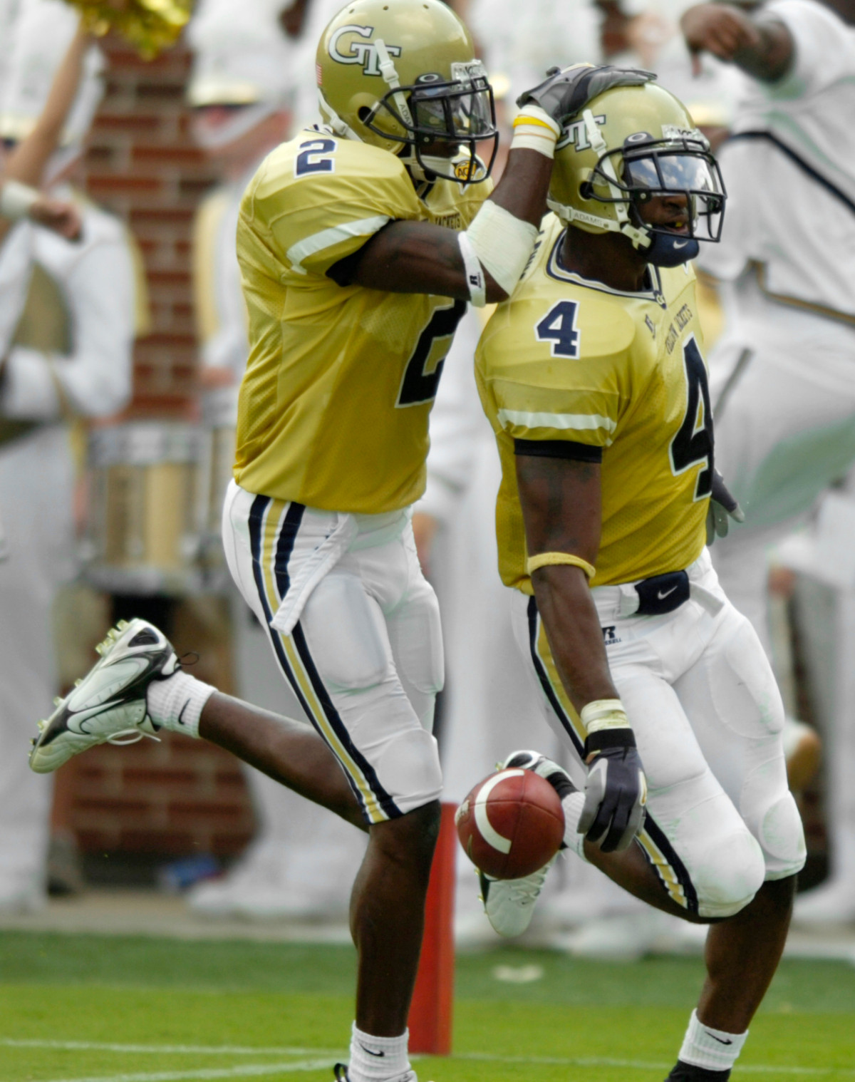 Jamal Lewis (4) is congratulated by cornerback Kenny Scott (2) as he scores on a 98-yard return of an interception in the first half. (AP Photo/Macon Telegraph, Woody Marshall)