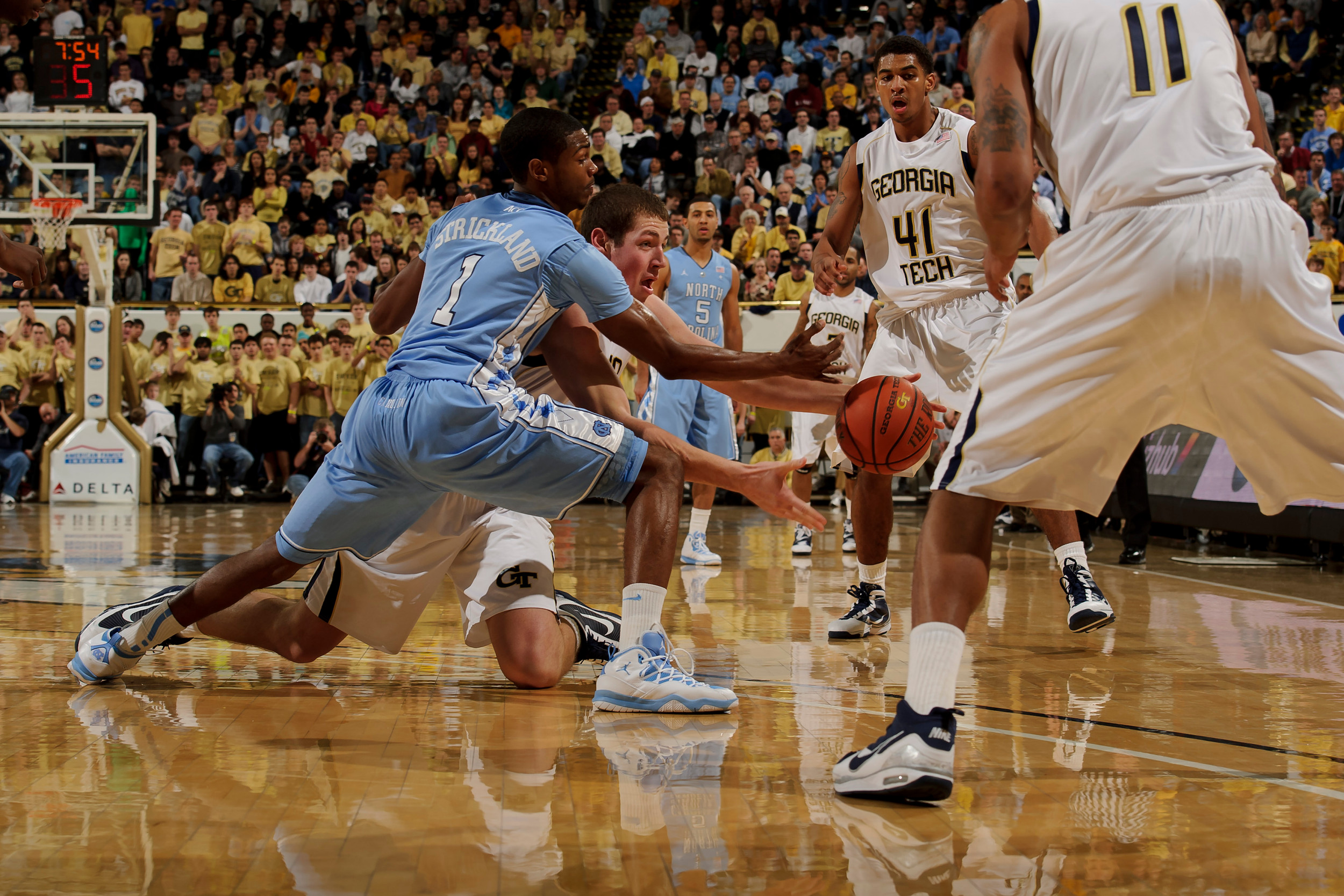 Jan 16, 2011; Atlanta, GA, USA; North Carolina Tar Heels guard Dexter Strickland (1) and Georgia Tech Yellow Jackets center Daniel Miller (5) scramble for a loose ball during the second half at Alexander Memorial Coliseum. Georgia Tech defeated North Carolina 78-58. Mandatory Credit: Paul Abell-Abell Images
