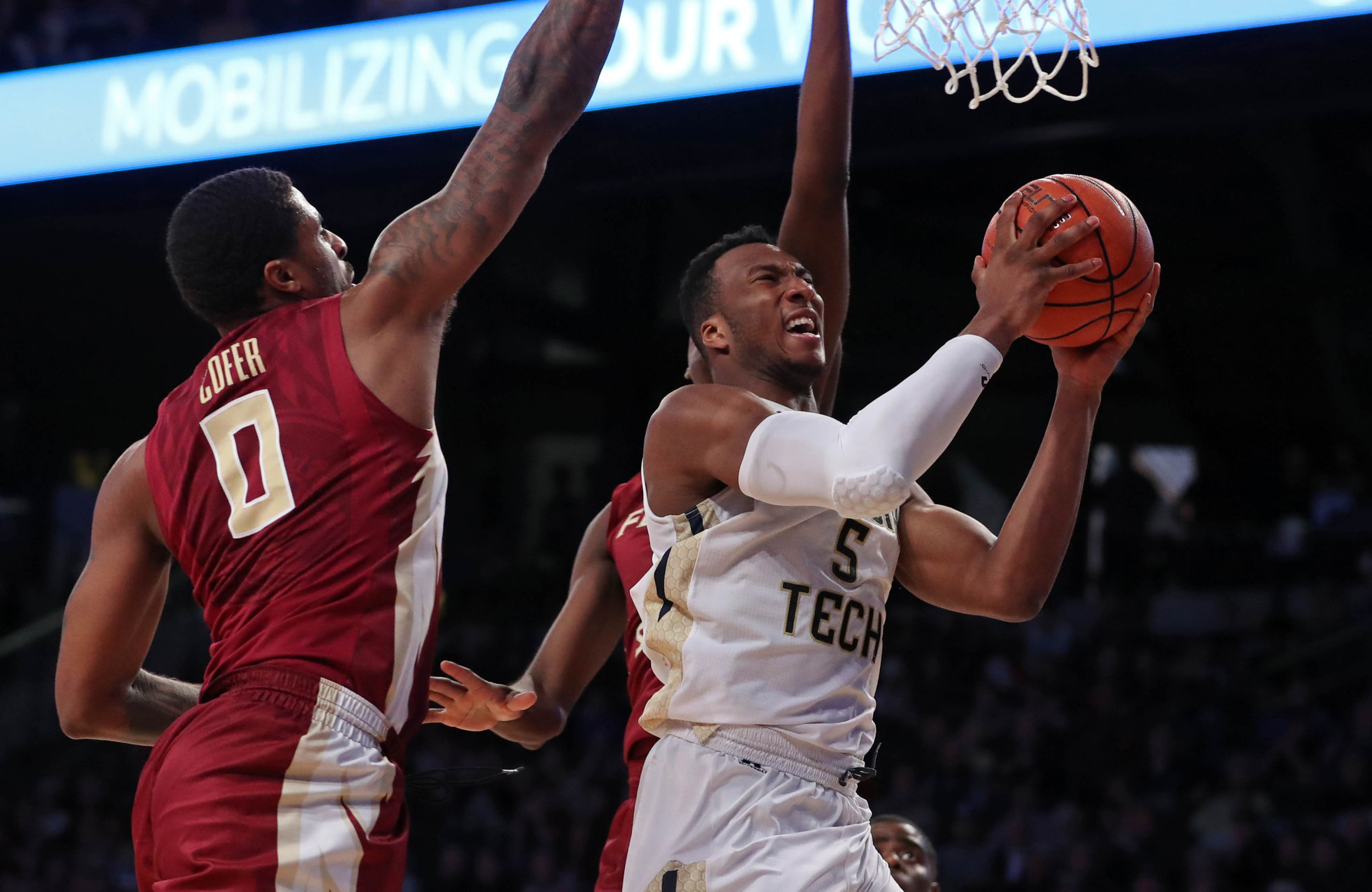 Jan 25, 2017; Josh Okogie (5) attempts a shot against Florida State Seminoles forward Phil Cofer (0) and forward Jonathan Isaac (1) in the second half of their game at McCamish Pavilion. The Yellow Jackets won 78-56. Credit: Jason Getz-USA TODAY Sports