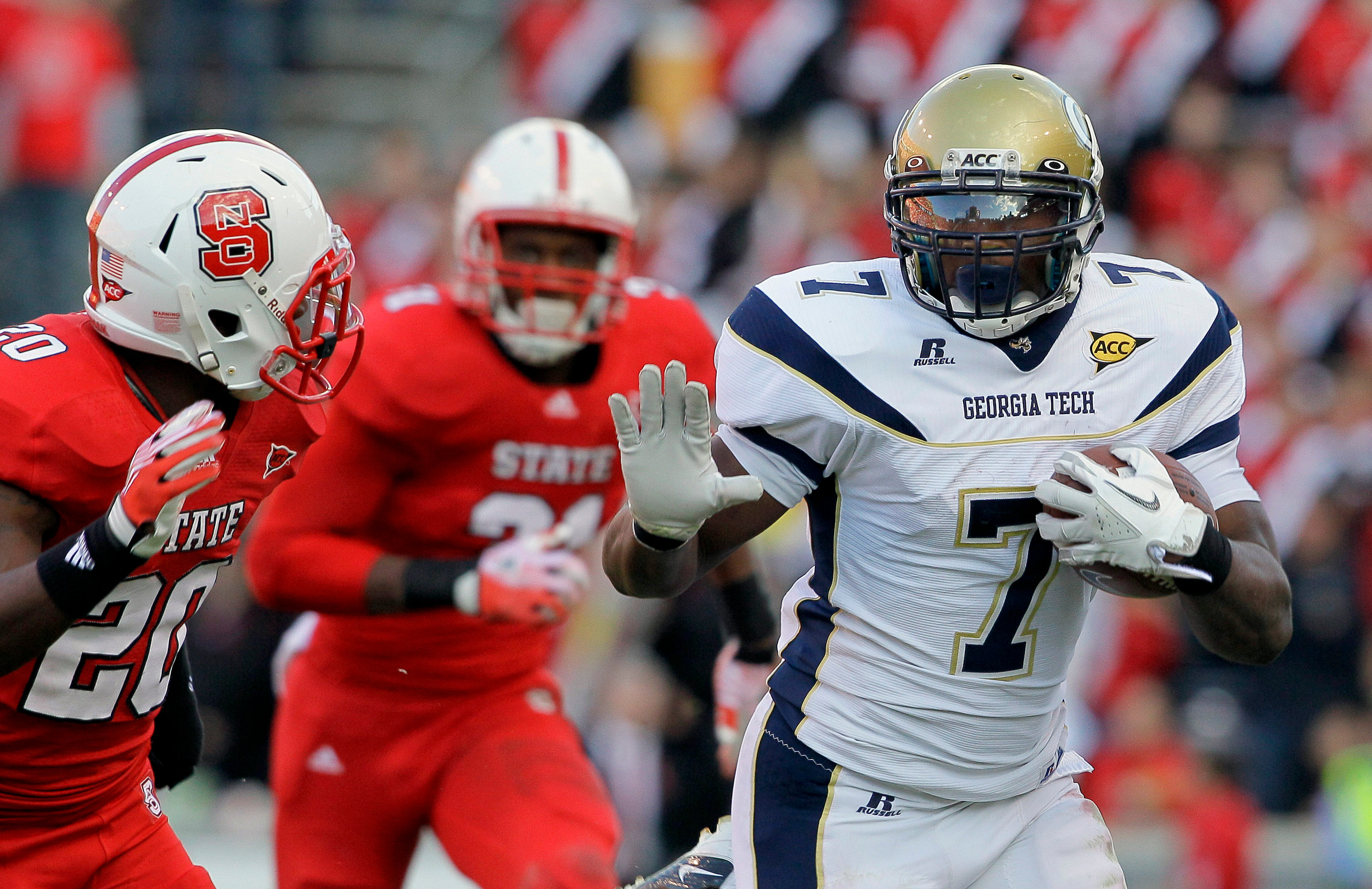 Georgia Tech's David Sims (7) escapes the NC State defense during Saturday's 45-35 victory over the Wolfpack. (AP Photo/Gerry Broome)