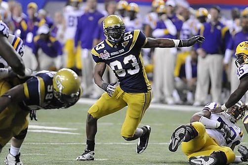 Michael Johnson (93) breaks through an opening in the line of scrimmage. Photo by LensEffects