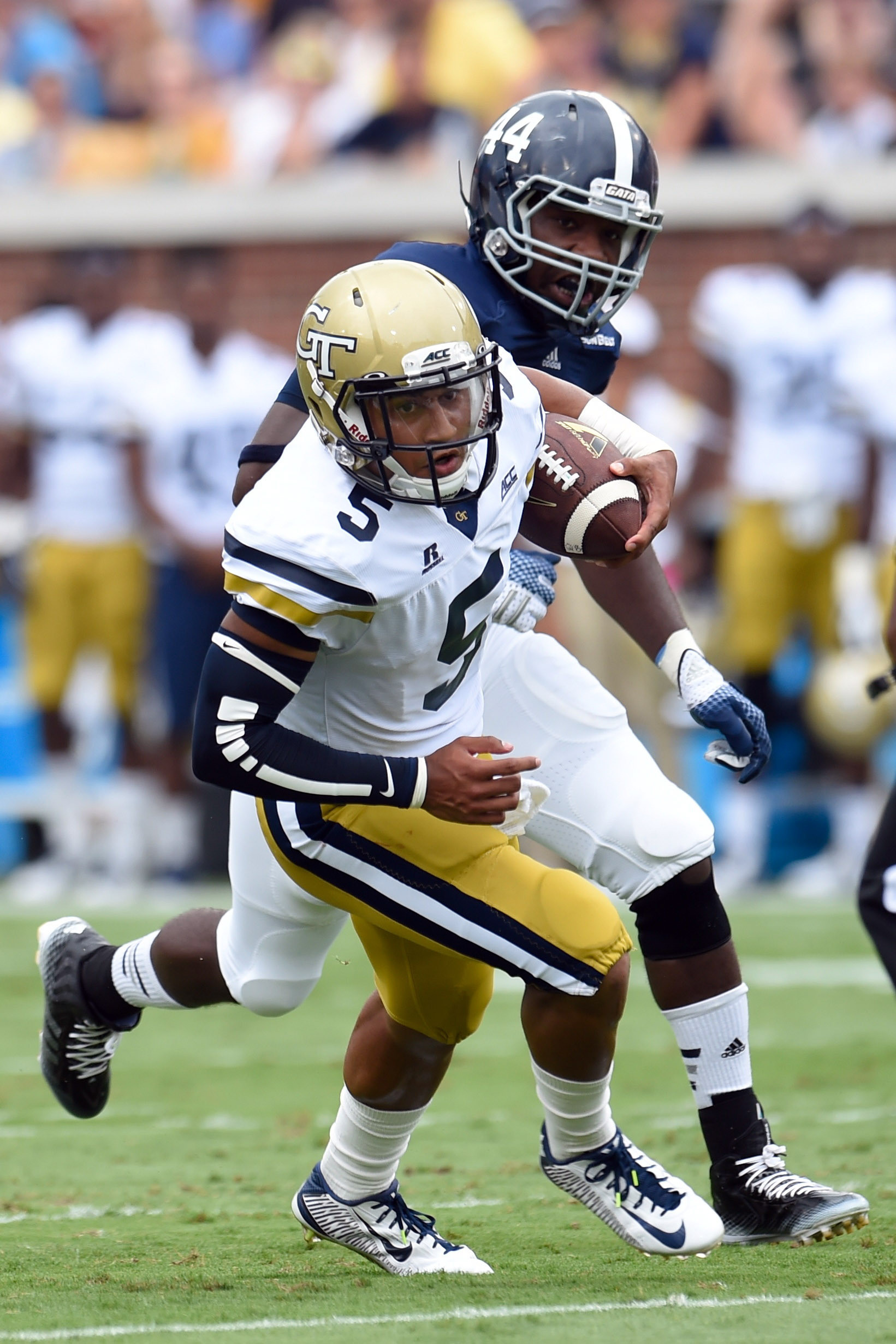 Sep 13, 2014; Atlanta, GA, USA; Yellow Jackets quarterback Justin Thomas (5) runs past Georgia Southern Eagles defensive end Quaun Daniels (44) during the first half. Dale Zanine-USA TODAY Sports