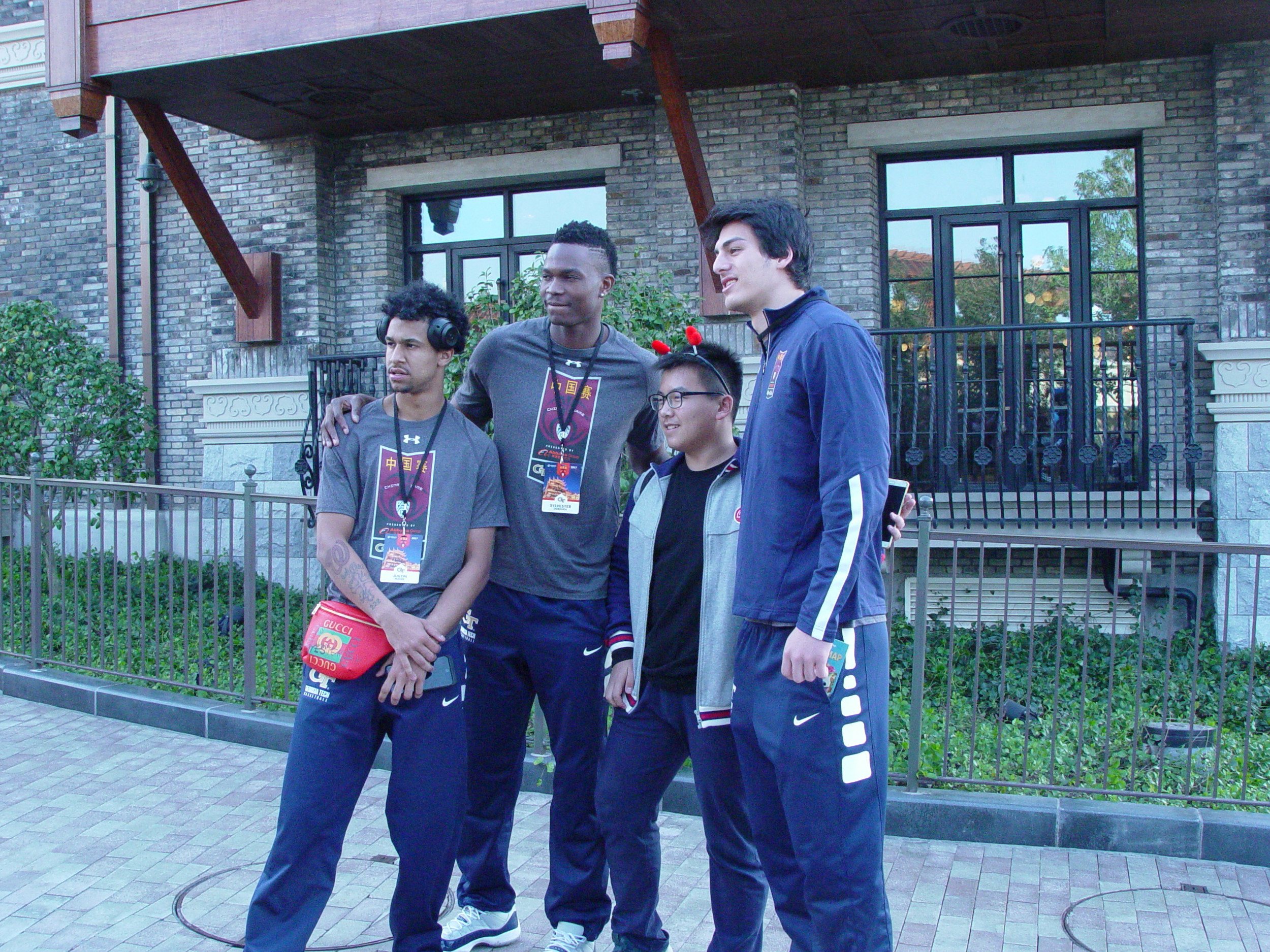 Justin Moore, Sylvester Ogbonda and Avi Schafer pose with a visitor to Shanghai Disney Resort - Shanghai, China, November 8, 2017