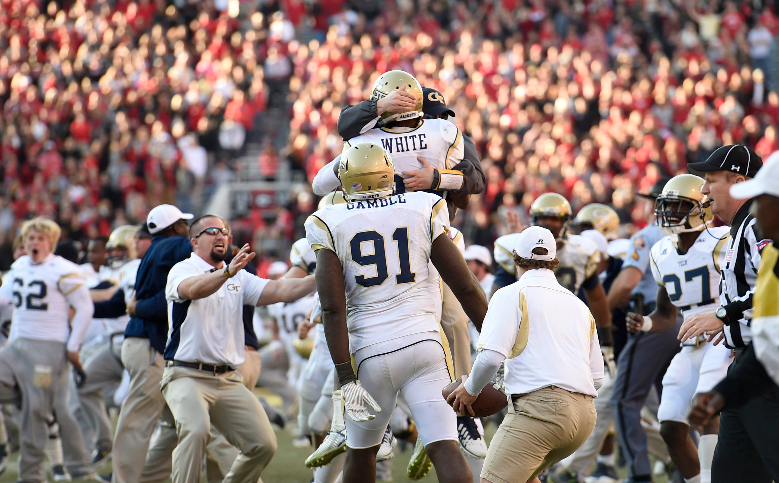 Nov 29, 2014; Athens, GA, USA; Yellow Jackets defensive back D.J. White (28) reacts with teammates and coaches after intercepting a pass to end the game. Dale Zanine-USA TODAY Sports