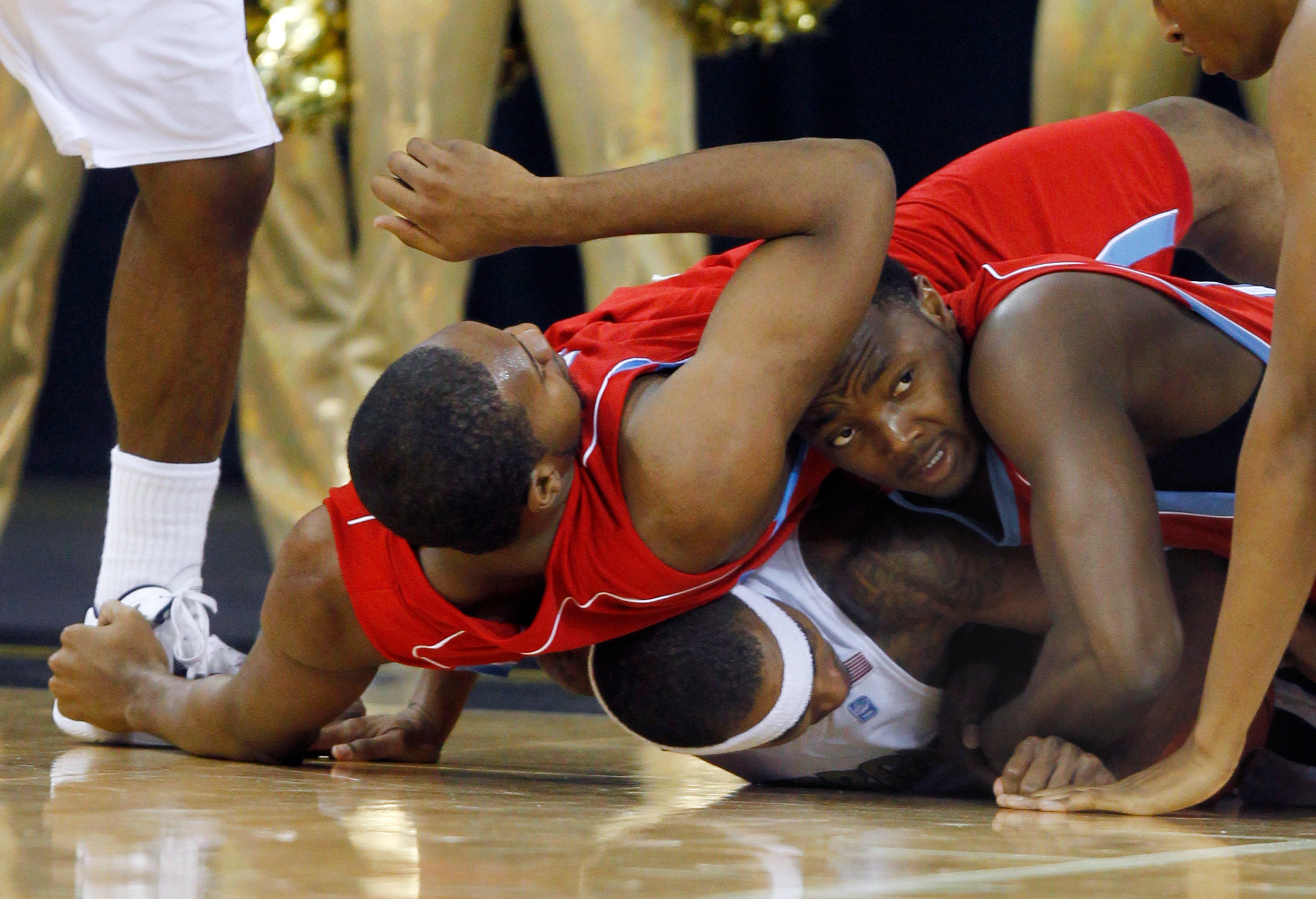 Georgia Tech guard Brandon Reed, bottom battles, Delaware State forward Marques Oliver, left, and center Kendall Gray for a loose ball in the first half. (AP Photo/John Bazemore)