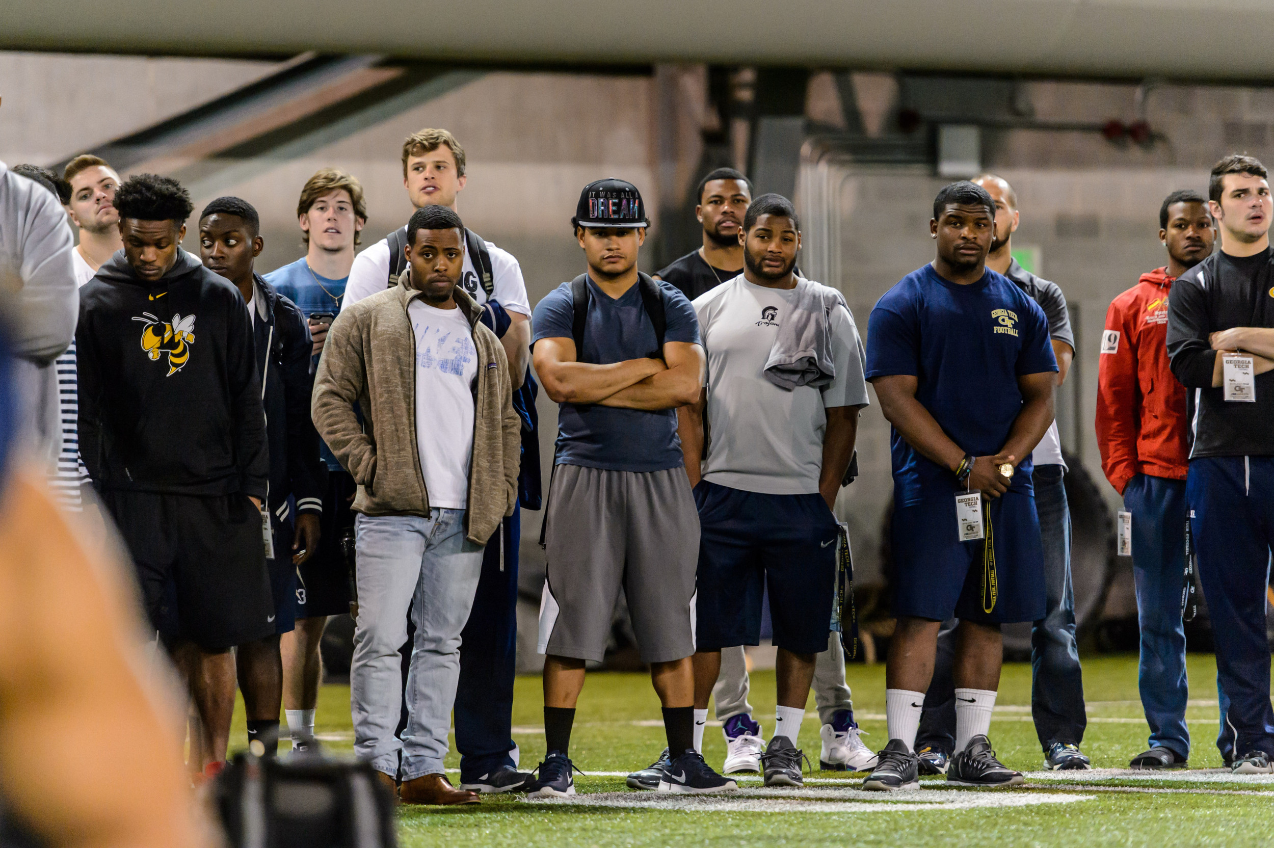 Current and former Georgia Tech players watch their teammates perform drills for NFL scouts at Pro Day