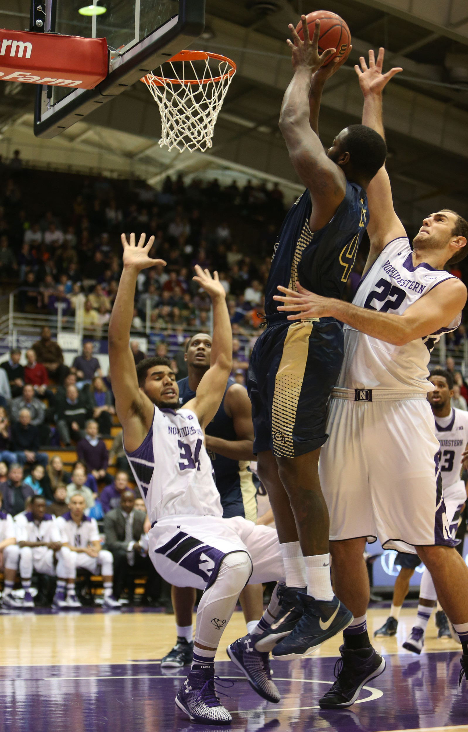 Georgia Tech Yellow Jackets center Demarco Cox (4) goes up for a shot while guarded by Northwestern Wildcats guard/forward Sanjay Lumpkin (34) and Northwestern Wildcats center Alex Olah (22) at Welsh-Ryan Arena. Mandatory Credit: Caylor Arnold-USA TODAY Sports