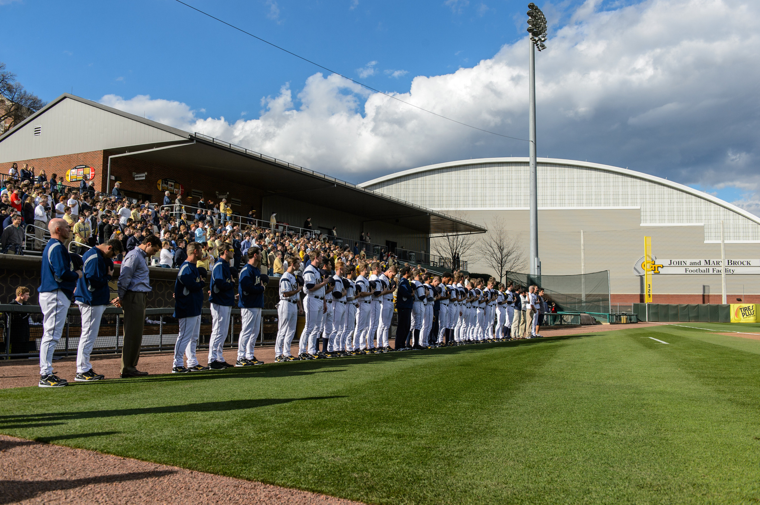 Georgia Tech players stand as the National Anthem is played.