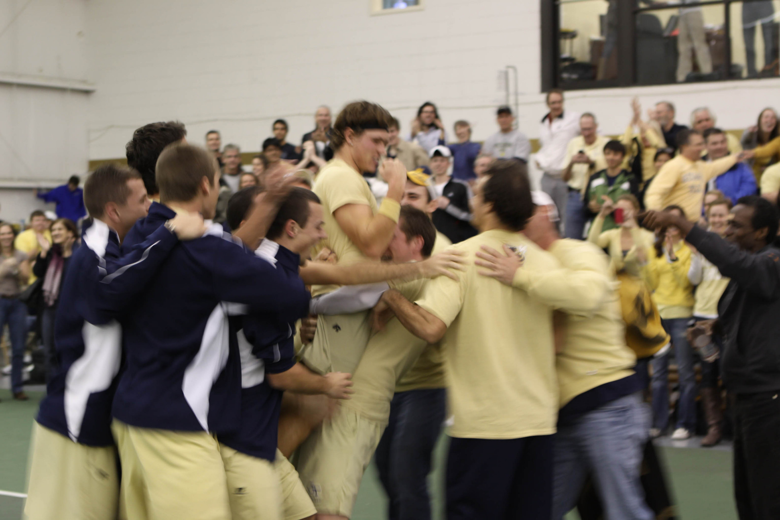 The men's tennis team celebrates their win over Georgia