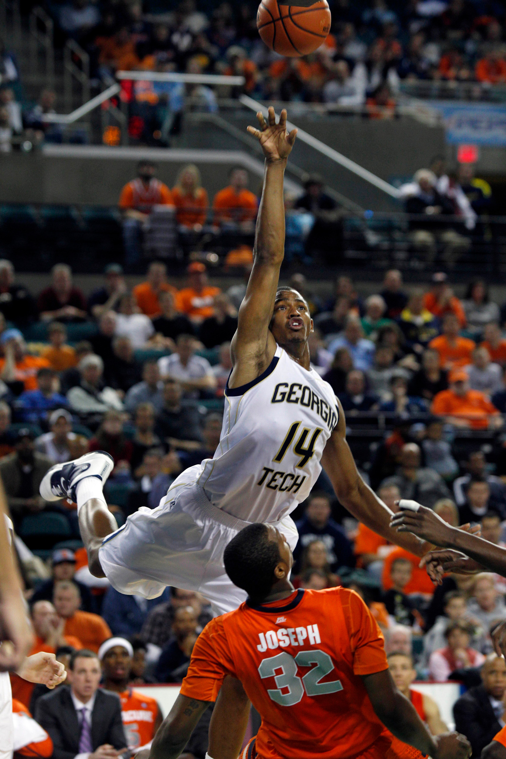 Georgia Tech's Jason Morris (14) flies over Syracuse's Kris Joseph (32) for a bucket. (AP Photo/Mel Evans)