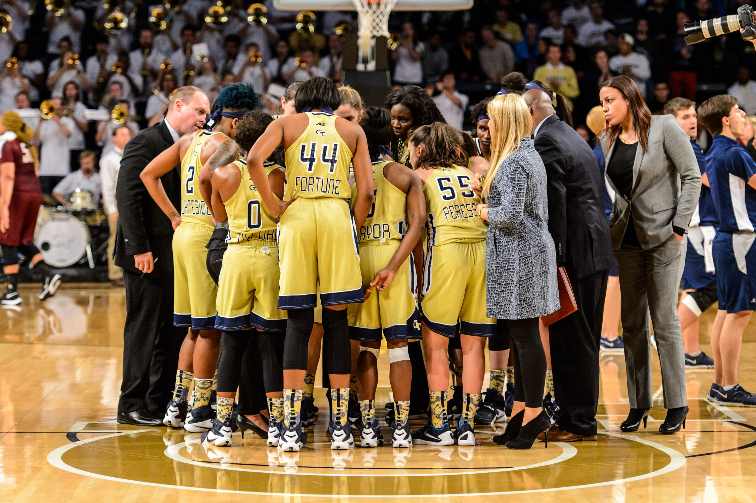 The Jackets huddle on the court after the win