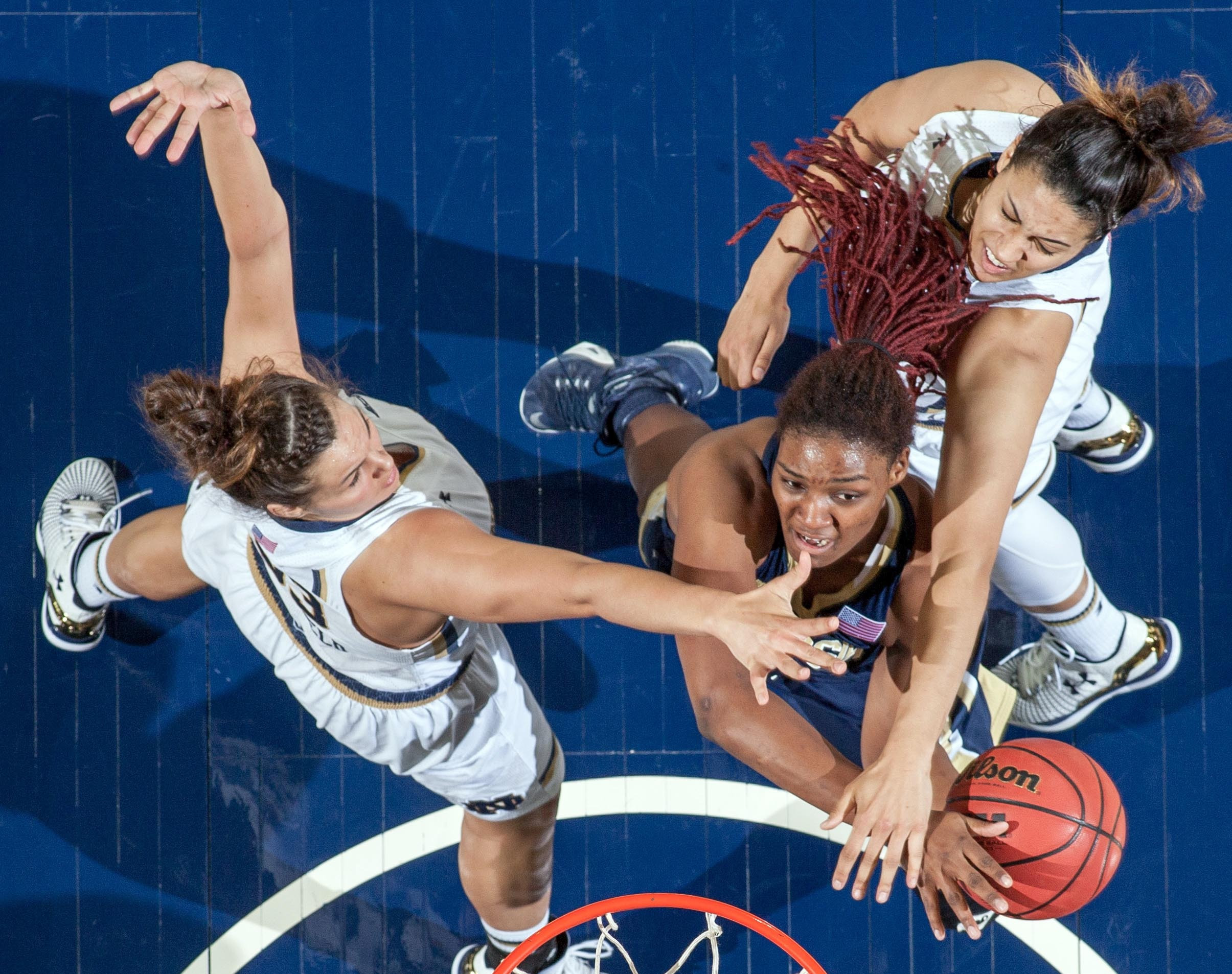 Roddreka Rogers goes up for a shot as Kathryn Westbeld and Taya Reimer defend. Credit: Matt Cashore-USA TODAY Sports