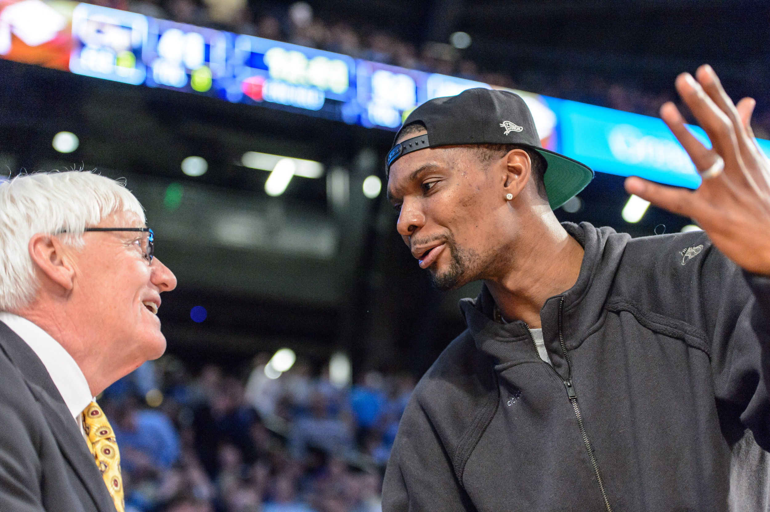 Chris Bosh speaks to Bobby Cremins during the game.