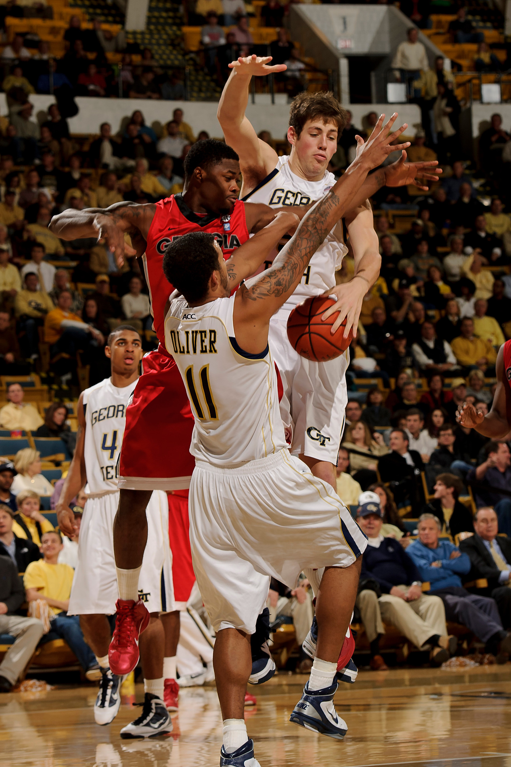 Dec 7, 2010; Atlanta, GA, USA; Georgia Tech Yellow Jackets center Daniel Miller (5) and forward Brian Oliver (11) fight for a rebound with a Georgia Bulldogs player during the first half at Alexander Memorial Coliseum. Georgia defeated Georgia Tech 73-72. Mandatory Credit: Paul Abell-US PRESSWIRE