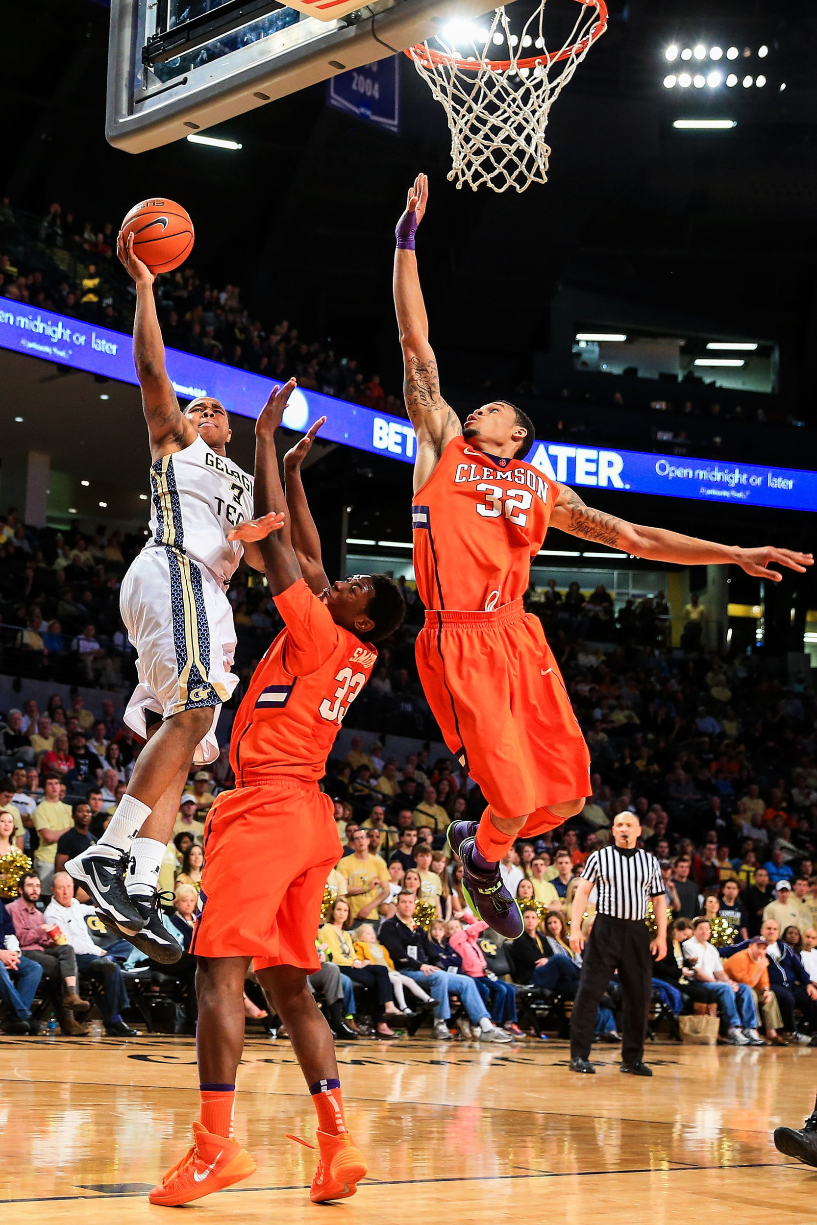Feb 22, 2014; Atlanta, GA, USA; Yellow Jackets forward Marcus Georges-Hunt (3) shoots a basket over Clemson Tigers forward/center Josh Smith (33) and forward K.J. McDaniels (32) in the second half. Daniel Shirey-USA TODAY Sports