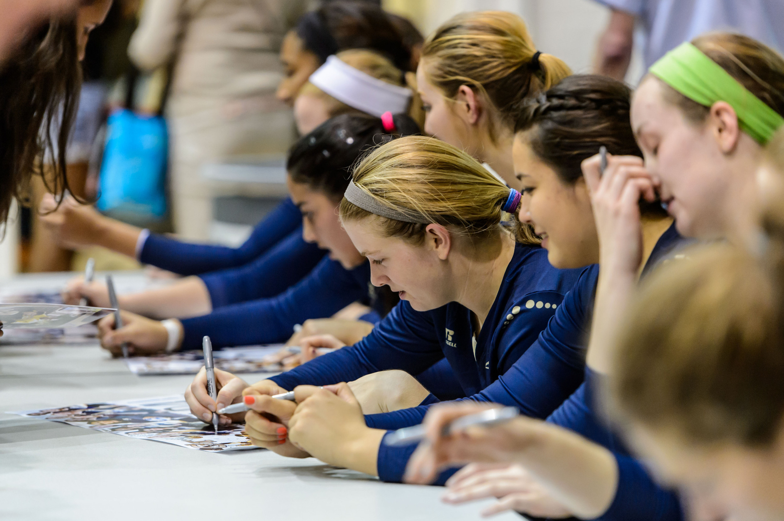 Teegan Van Gunst (7) and the Yellow Jackets sign autographs after the win