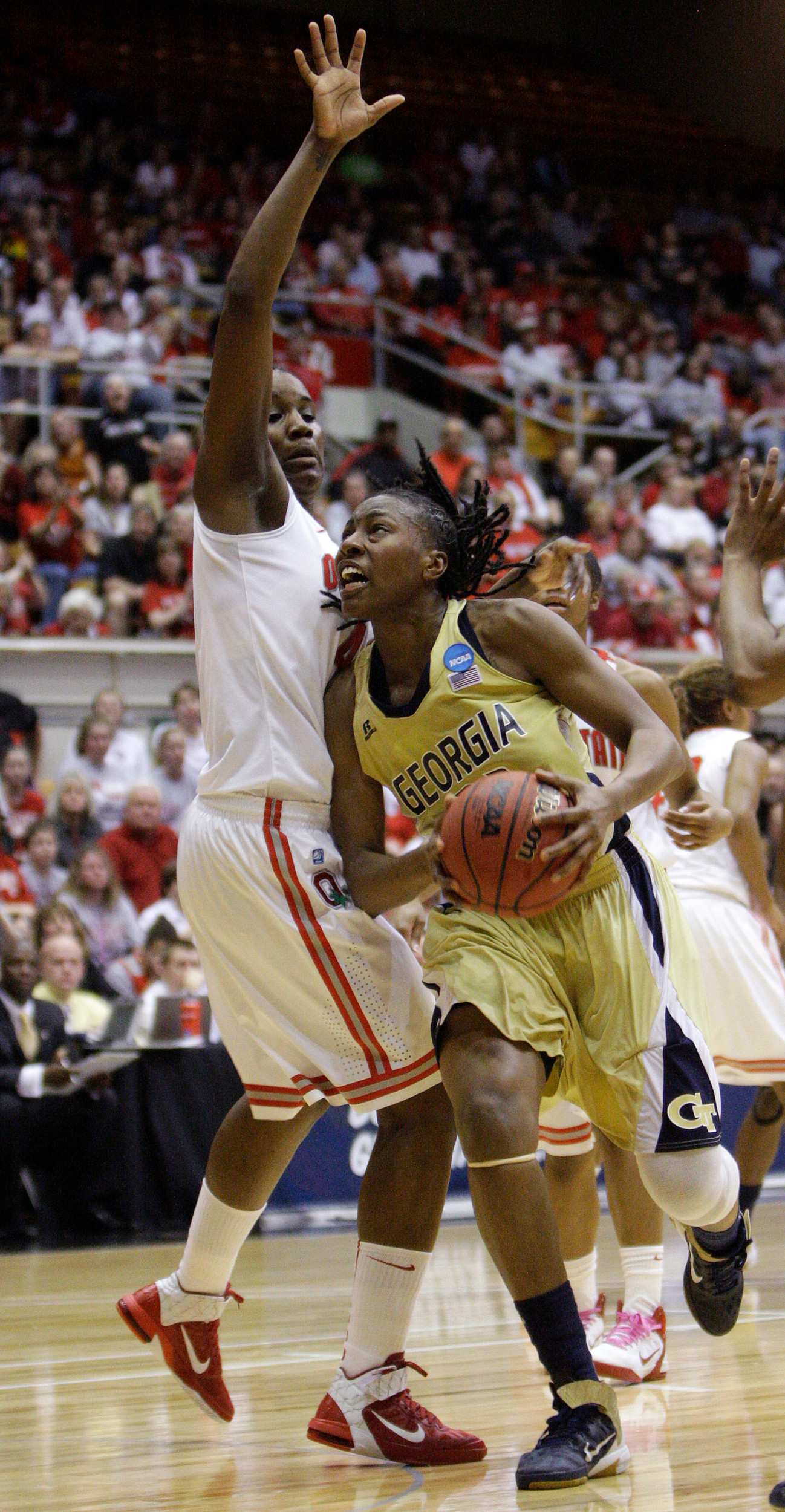 Georgia Tech's Chelsea Regins, right, drives to the basket against Ohio State's Jantel Lavende. (AP Photo/Jay LaPrete)