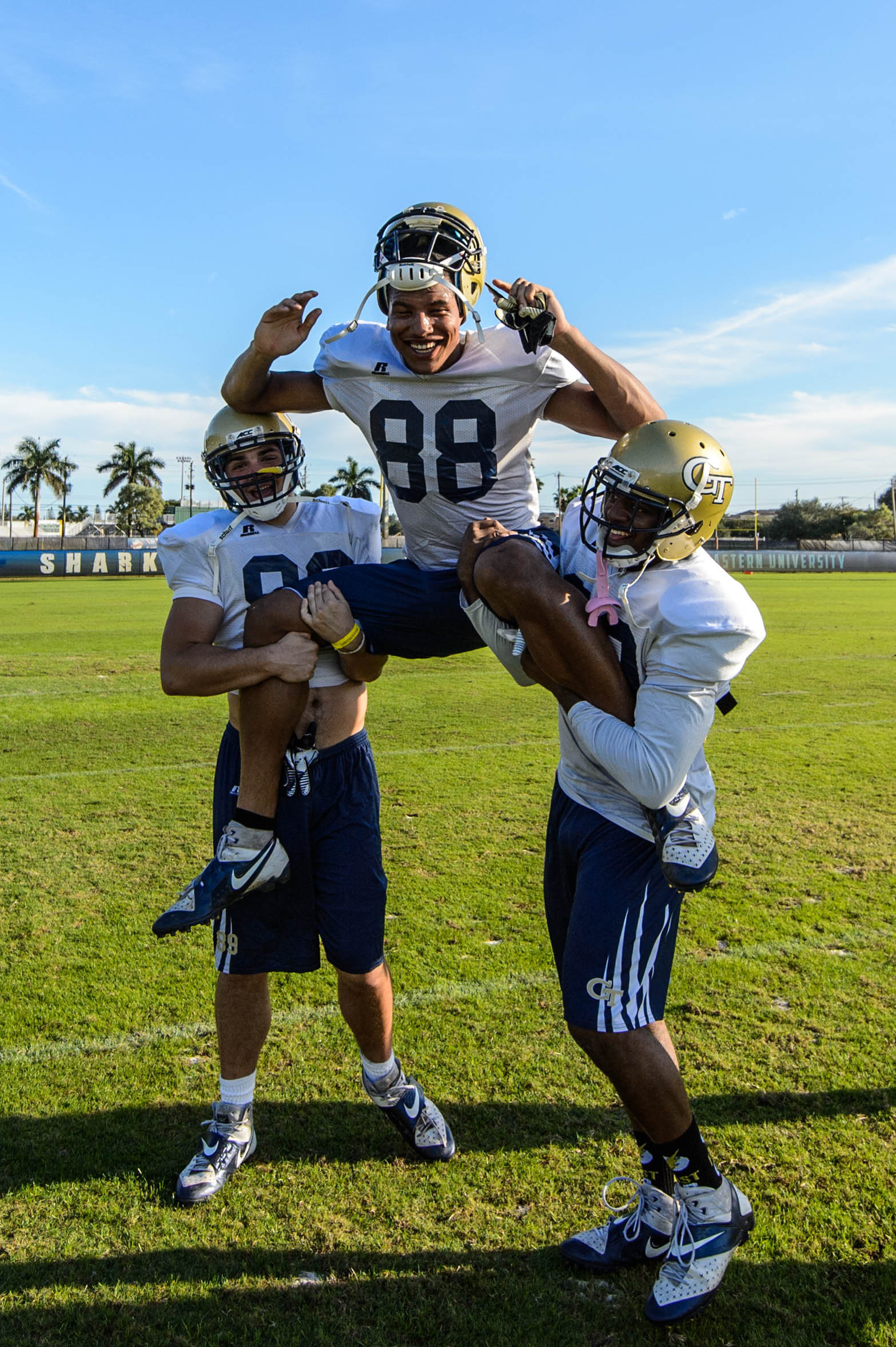 Bennett Barton (89) & Brandon Oliver (80) carry senior Darren Waller (88) off the field after his final practice as a Yellow Jacket