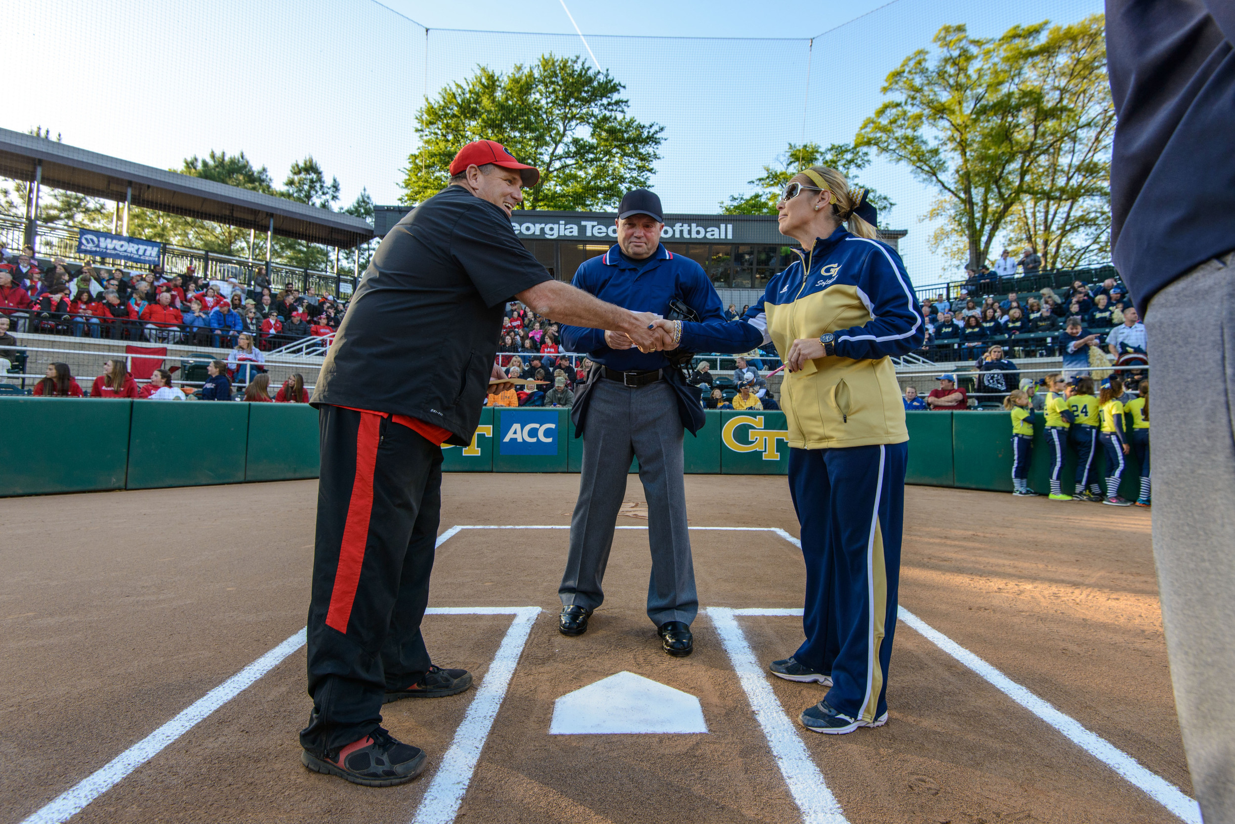 The coaches shake hands at the plate