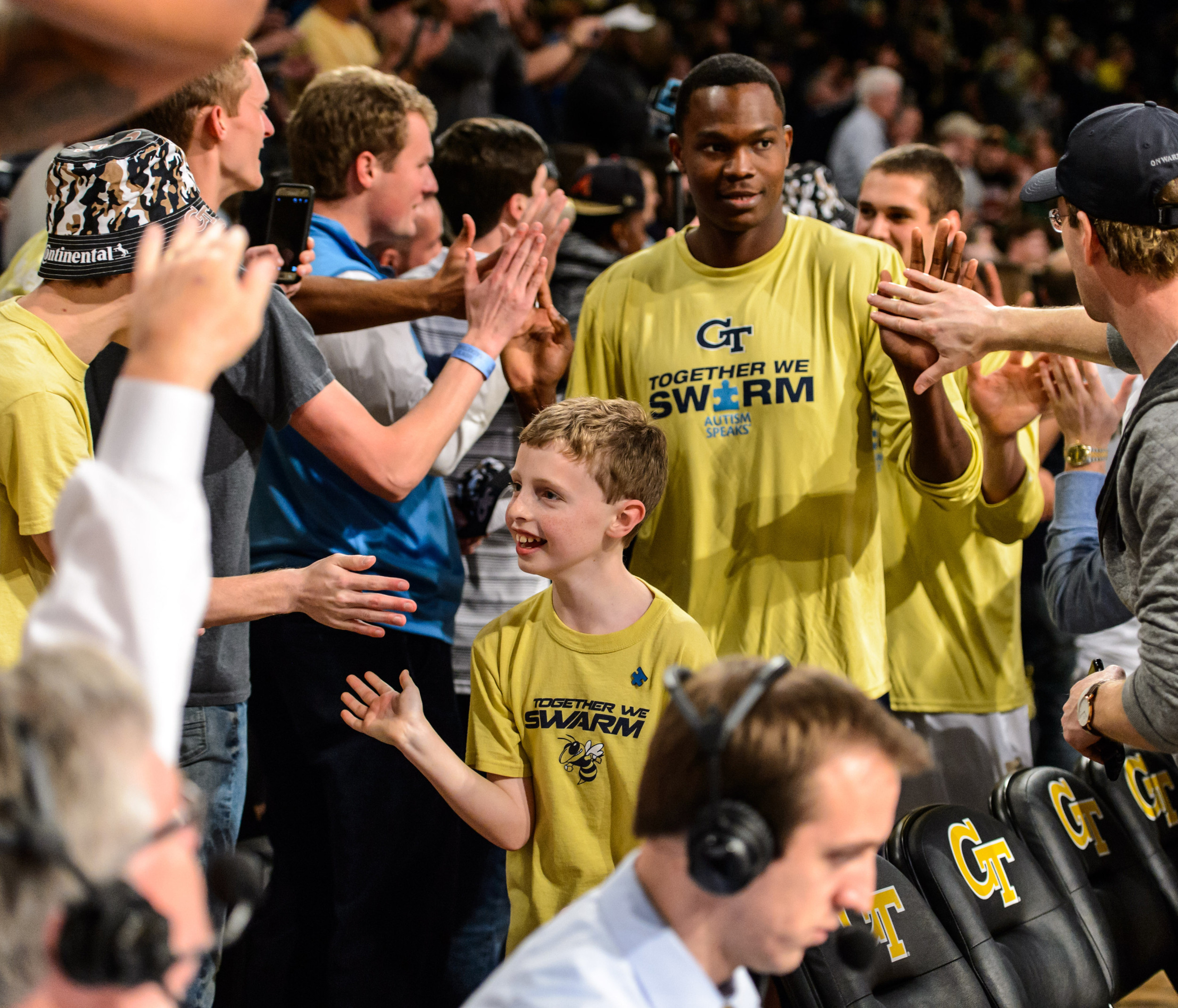 Robert Herrion and the Jackets high-five fans after the win