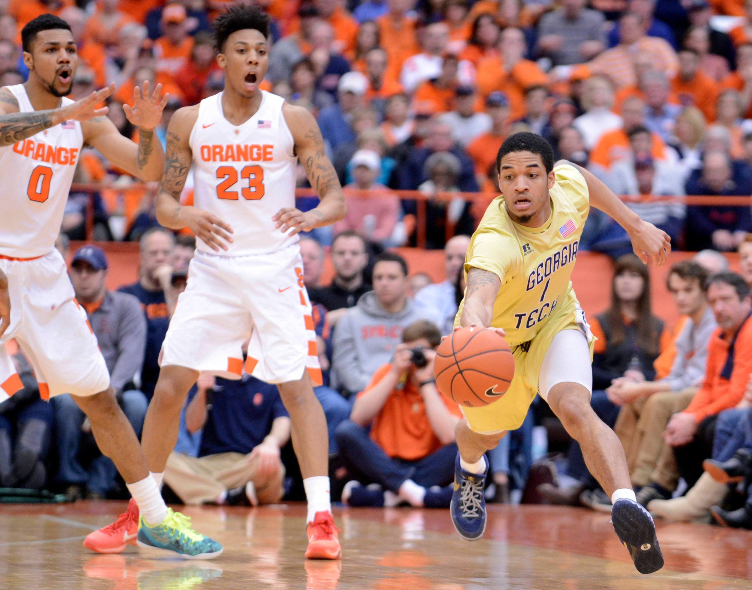 Tadric Jackson (1) gets hold of a loose ball as Syracuse Orange forward Michael Gbinije (0) and guard Malachi Richardson (23) react during the second half. Mark Konezny-USA TODAY Sports