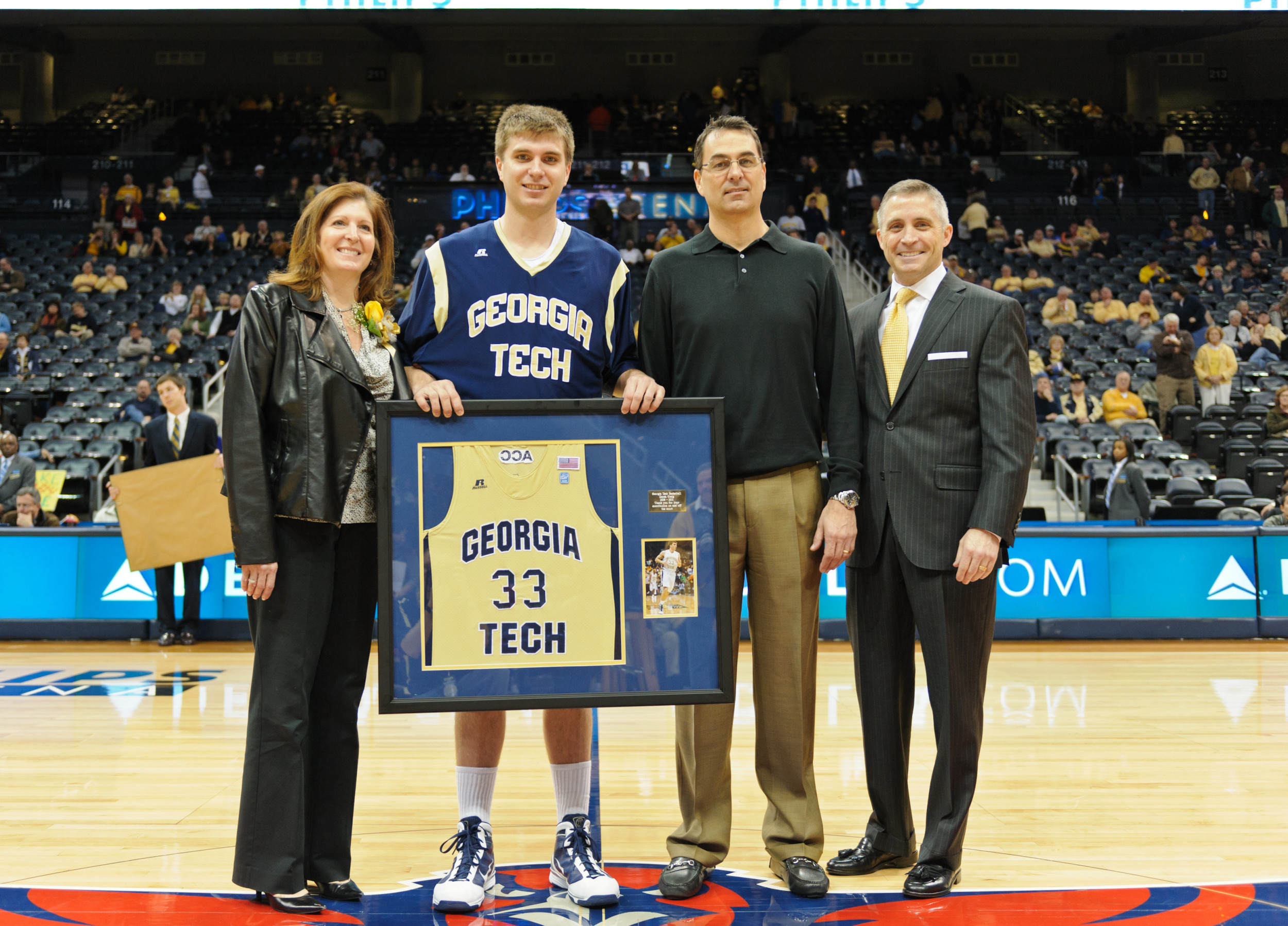 Derek Craig (33) is honored before the game.