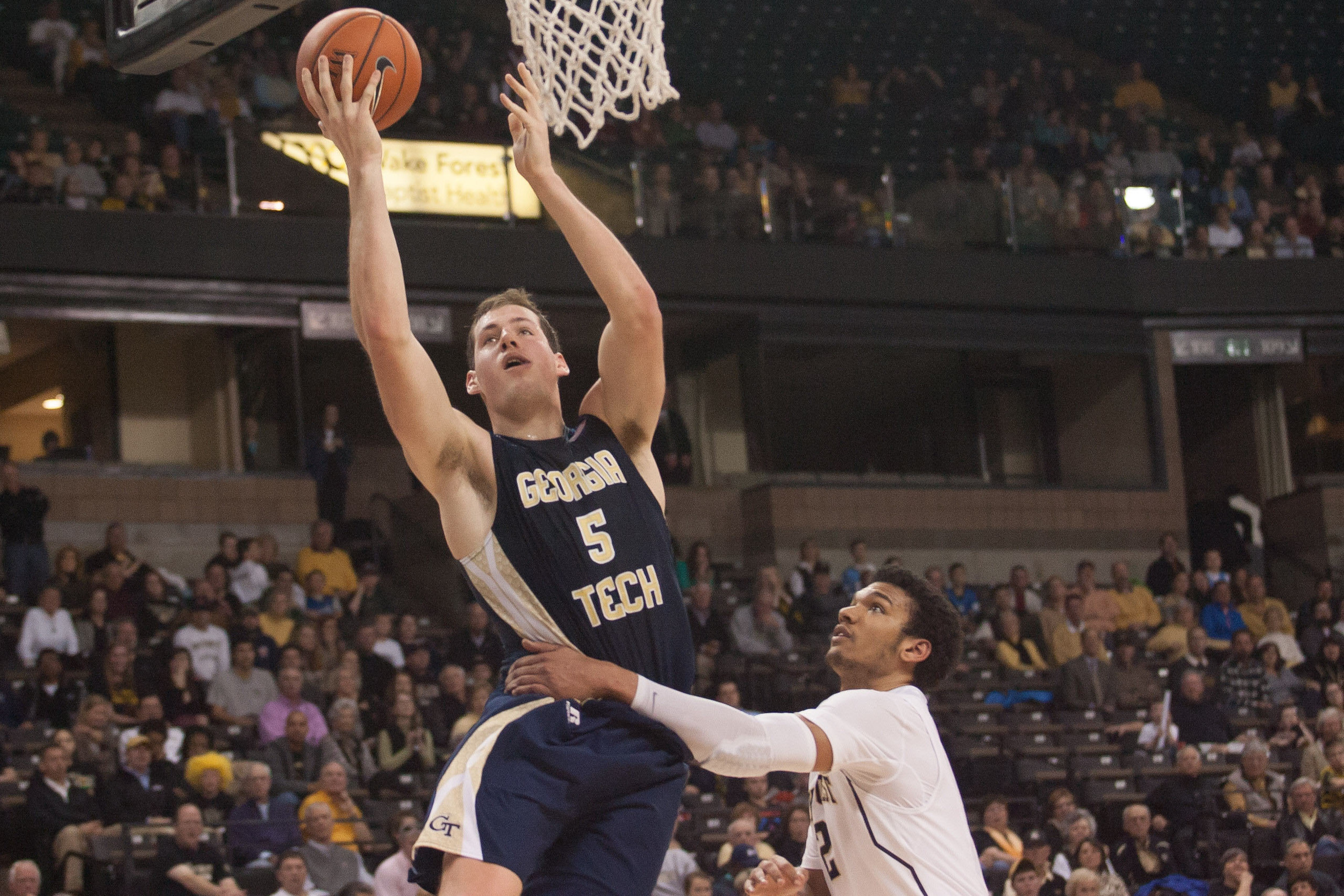 Feb 1, 2014; Winston-Salem, NC, USA; Yellow Jackets center Daniel Miller (5) is grabbed by Wake Forest Demon Deacons forward Devin Thomas (2) during the second half. Jeremy Brevard-USA TODAY Sports