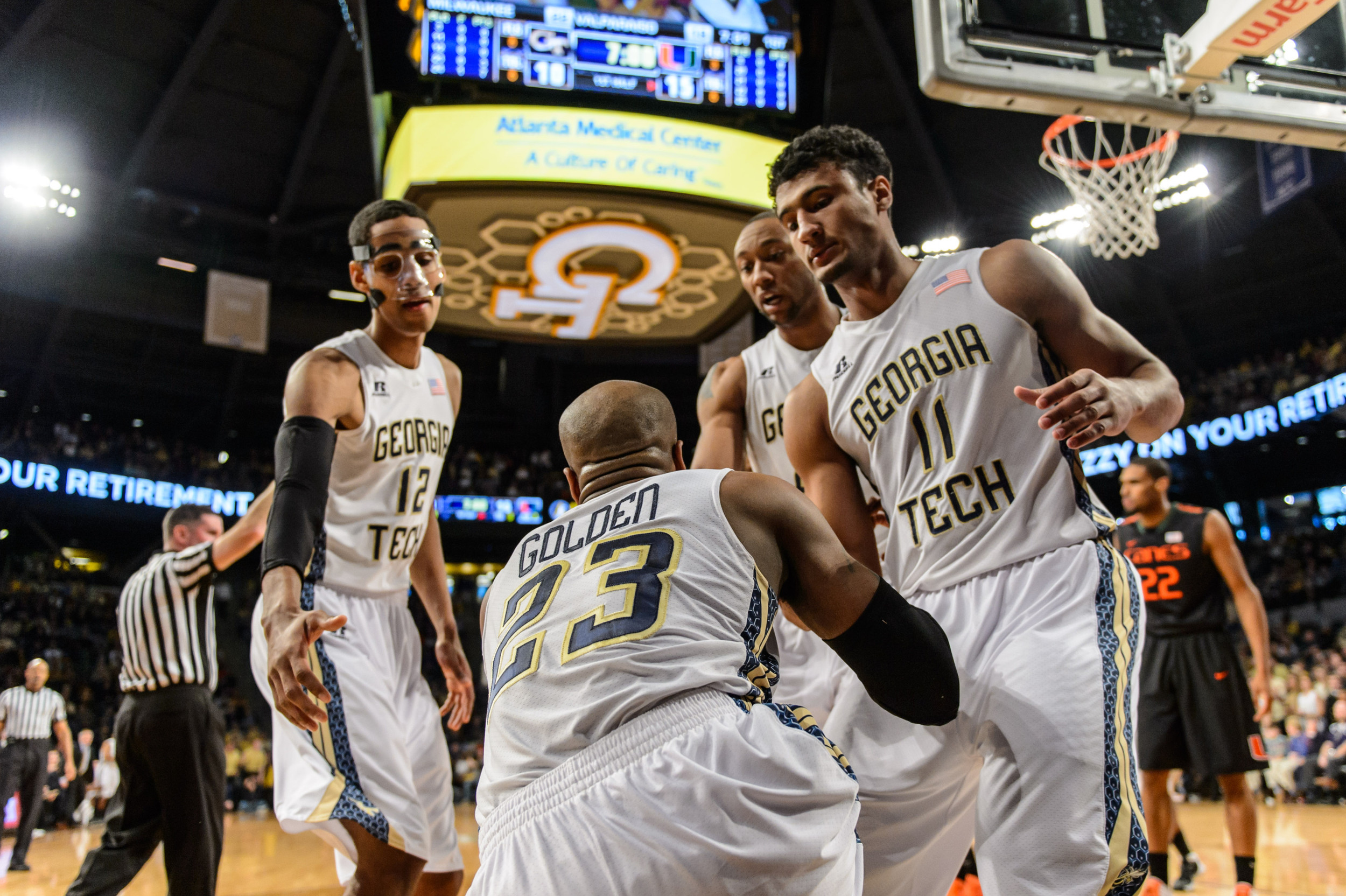Trae Golden (23) is helped up by teammates.