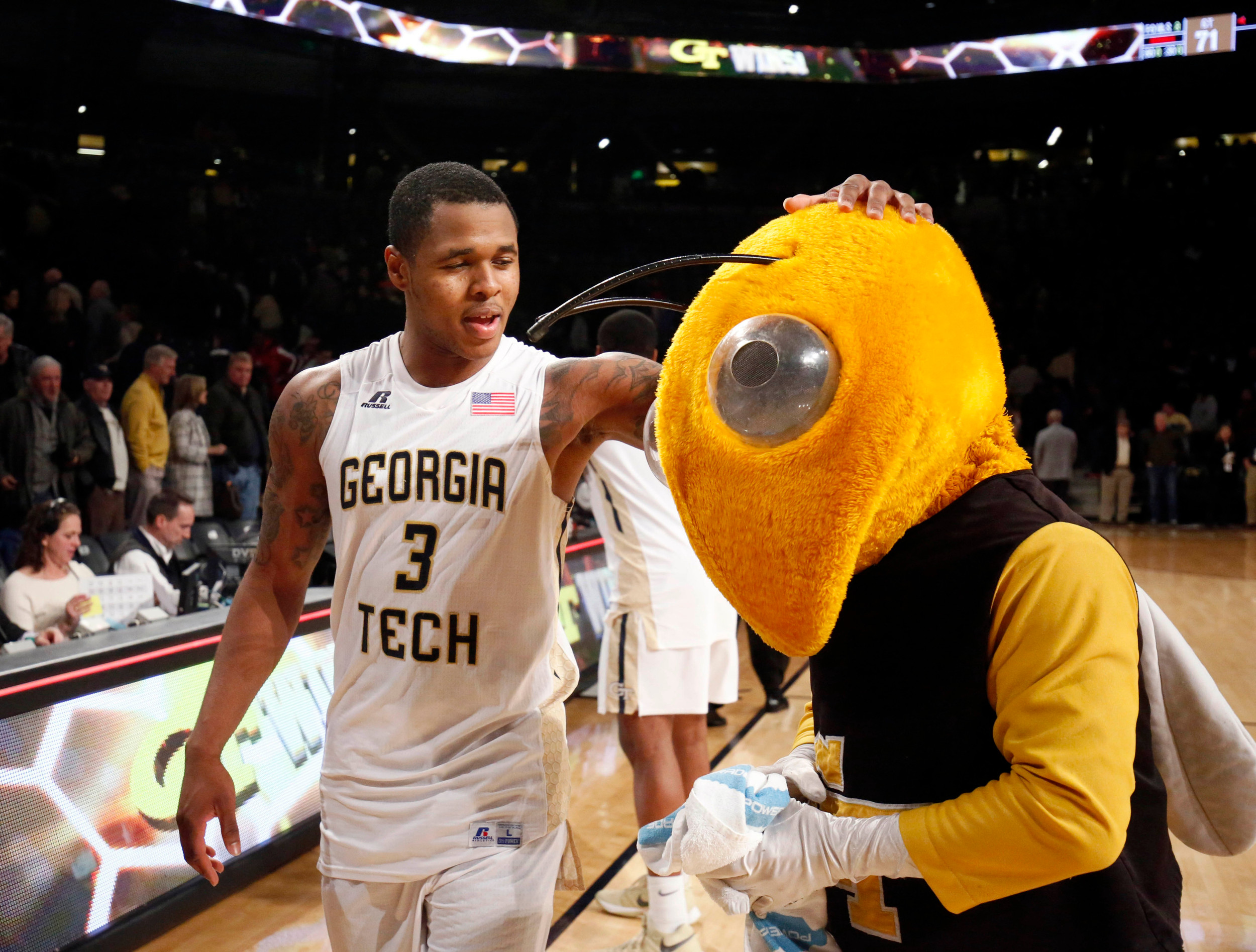 Feb 10, 2016; Atlanta, GA, USA; Georgia Tech Yellow Jackets guard Marcus Georges-Hunt (3) celebrates with Georgia Tech Yellow Jackets mascot Buzz. Credit: Jason Getz-USA TODAY Sports